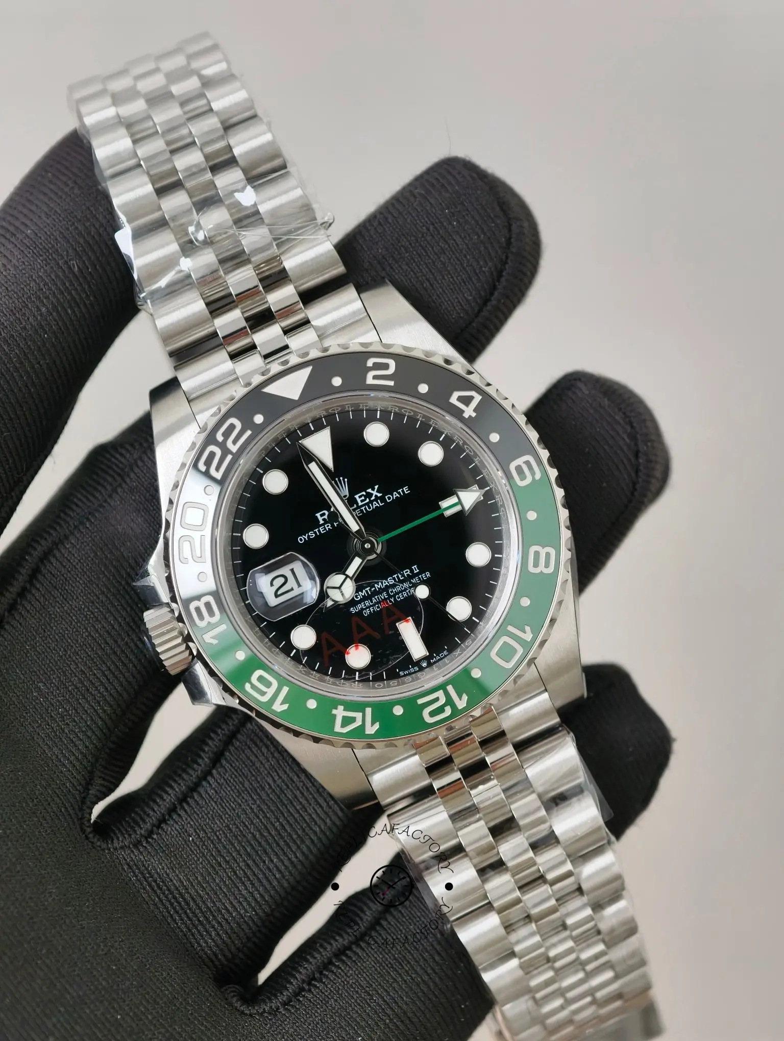Front angled view of Rolex GMT-Master II 126720VTNR with black dial and Jubilee bracelet in hand.