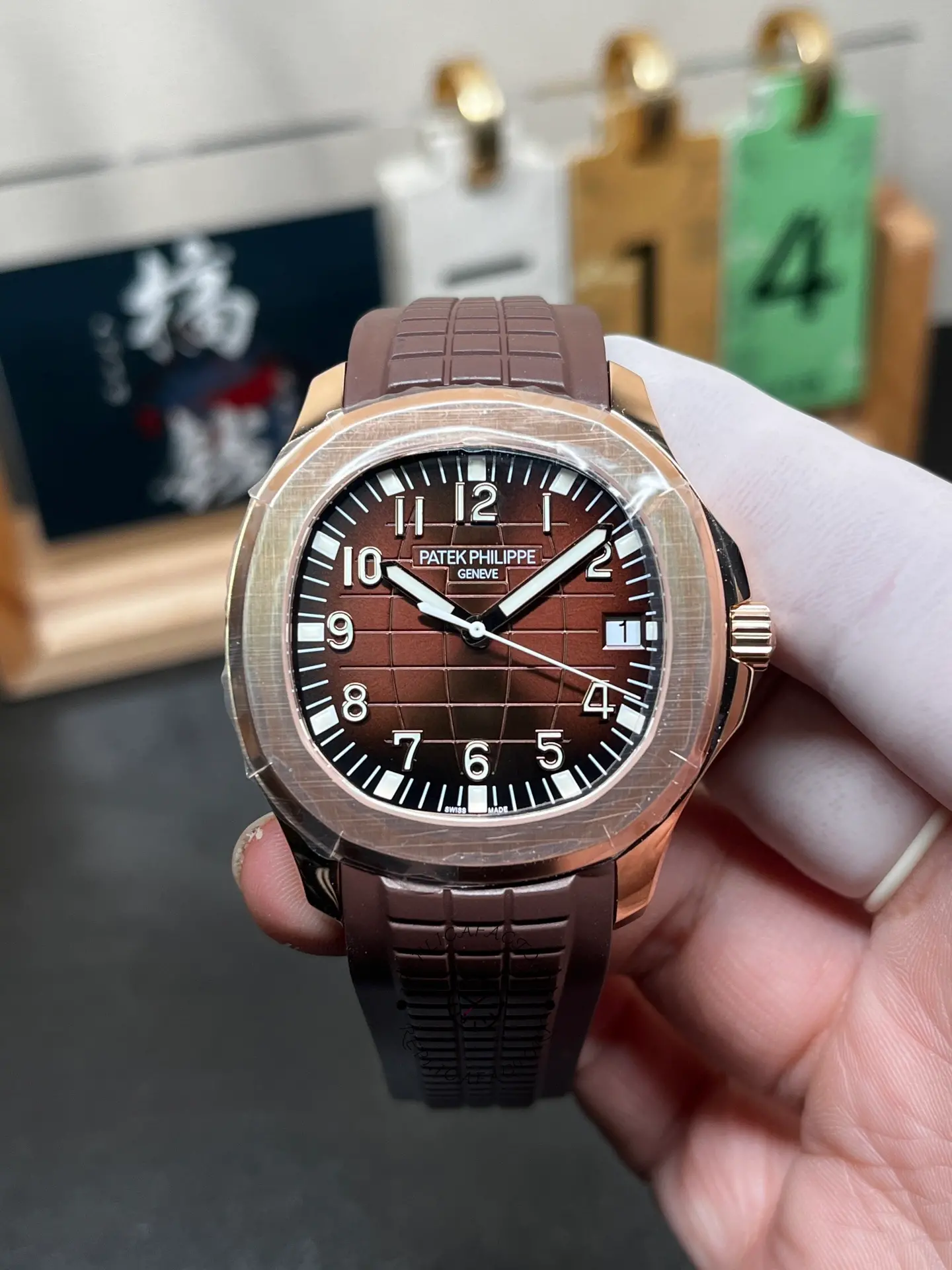 Patek Philippe Aquanaut 5167R-001 dial close-up, luminous numerals and checkerboard texture.