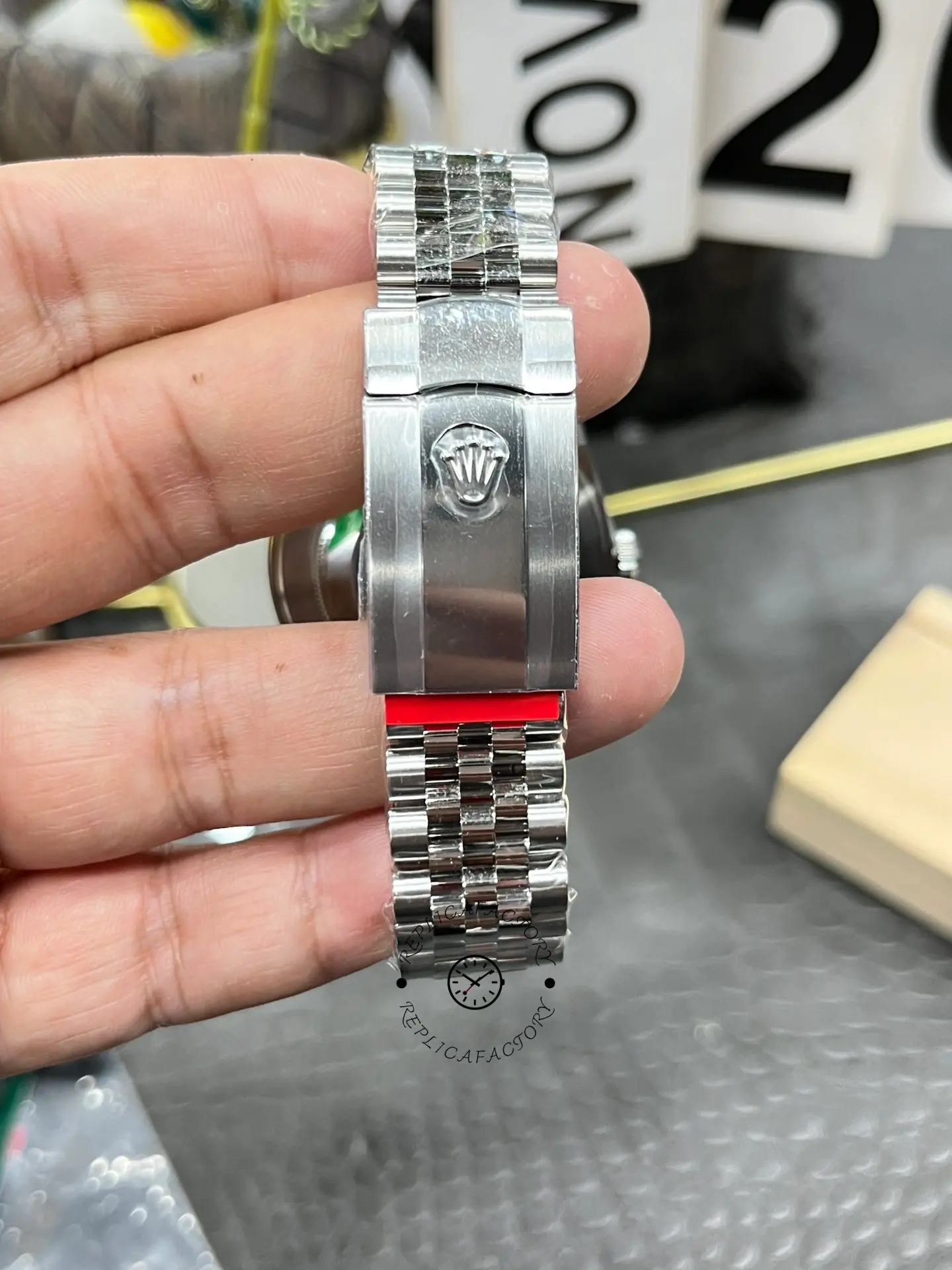 Clasp close-up of Rolex Datejust 126334-0022 showing the exterior clasp cover with Rolex crown logo.