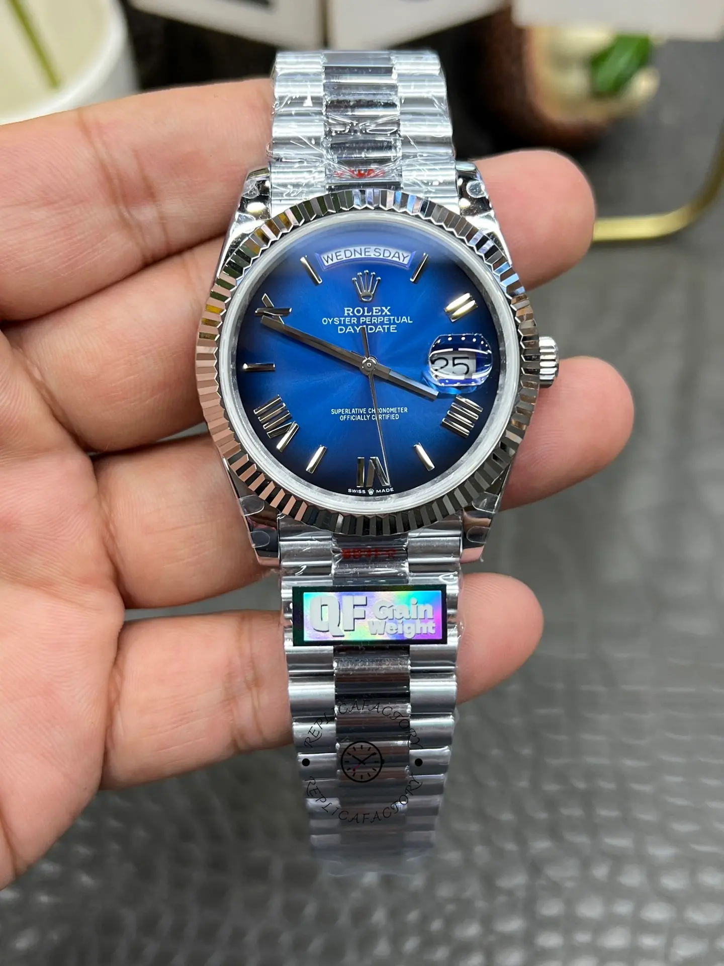 Straight front view of Rolex Day-Date 228239-0076 showing Wednesday day window and date magnifier.