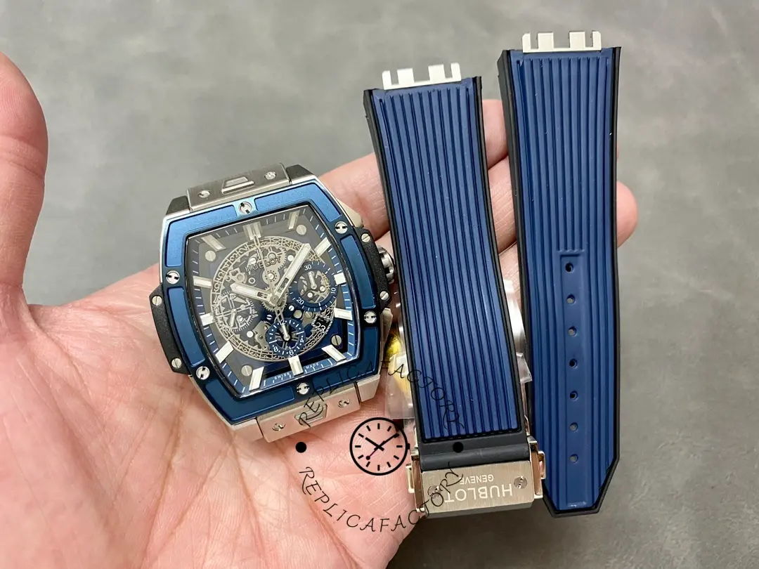 Hublot 642.NL.7170.RX watch head with separate blue rubber strap pieces displayed next to it.