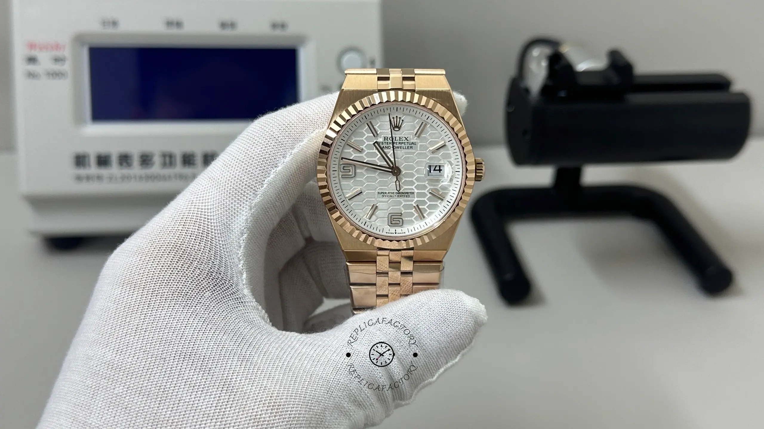 Front view of Rolex Land-Dweller M127235-0001 with honeycomb dial, fluted bezel, date window, and rose gold bracelet.