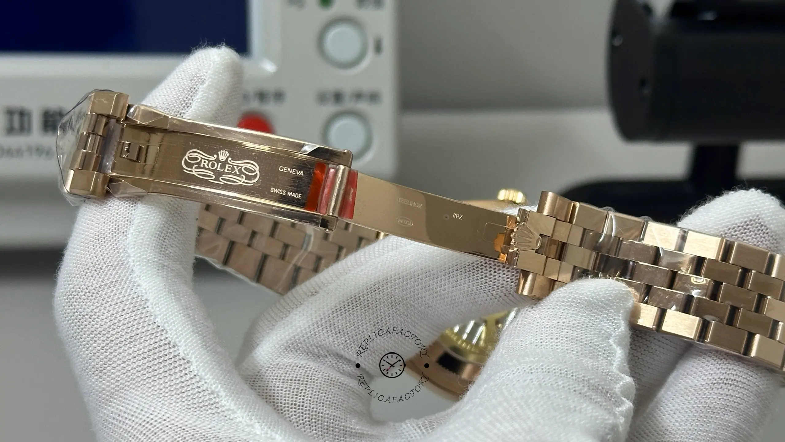 Interior clasp view of Rolex Land-Dweller M127235-0001 showing engraved clasp details and polished metal finish.