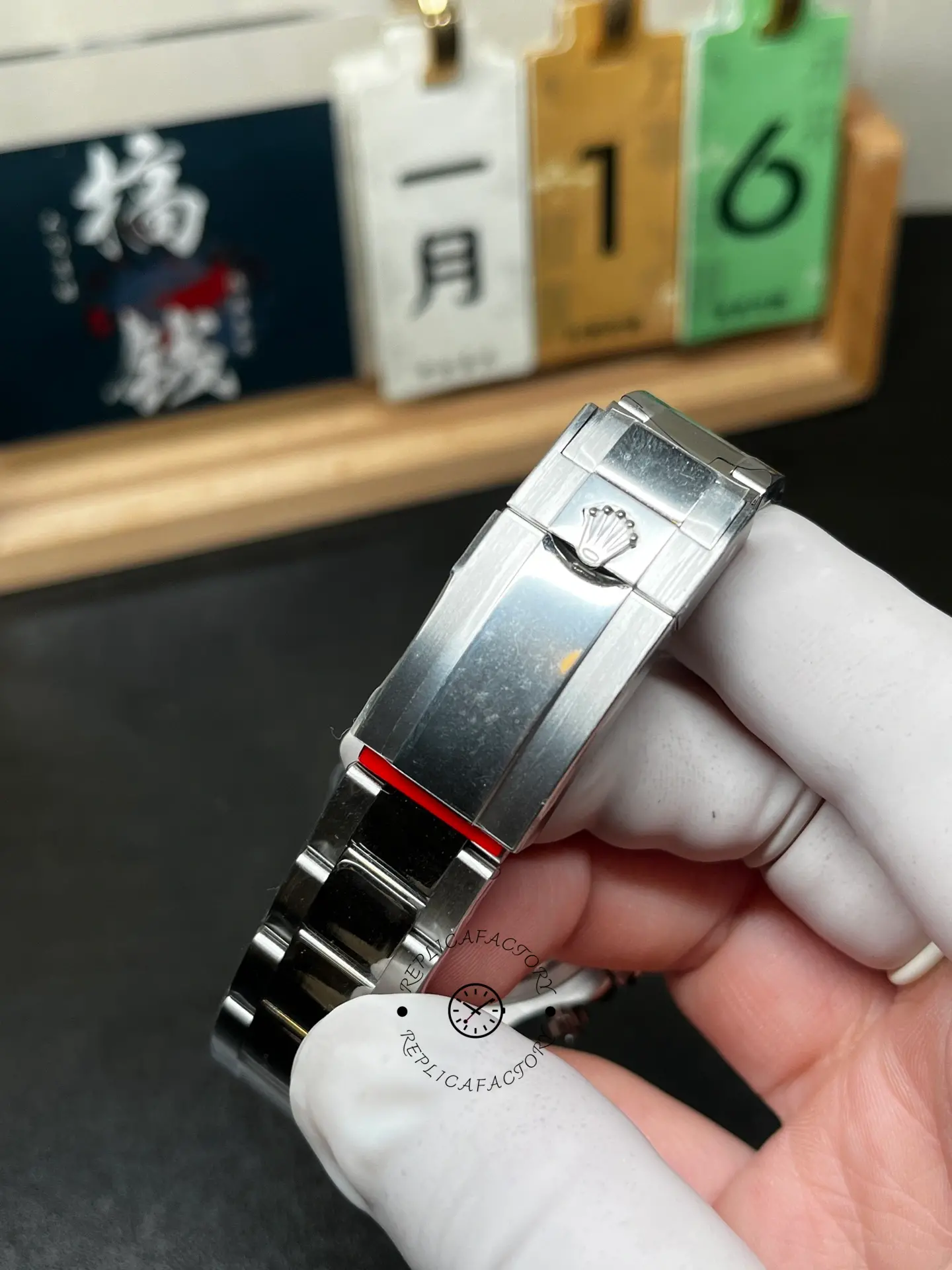 Clasp close-up of Rolex m126500ln-0002 Oyster bracelet showing signed crown clasp detail.