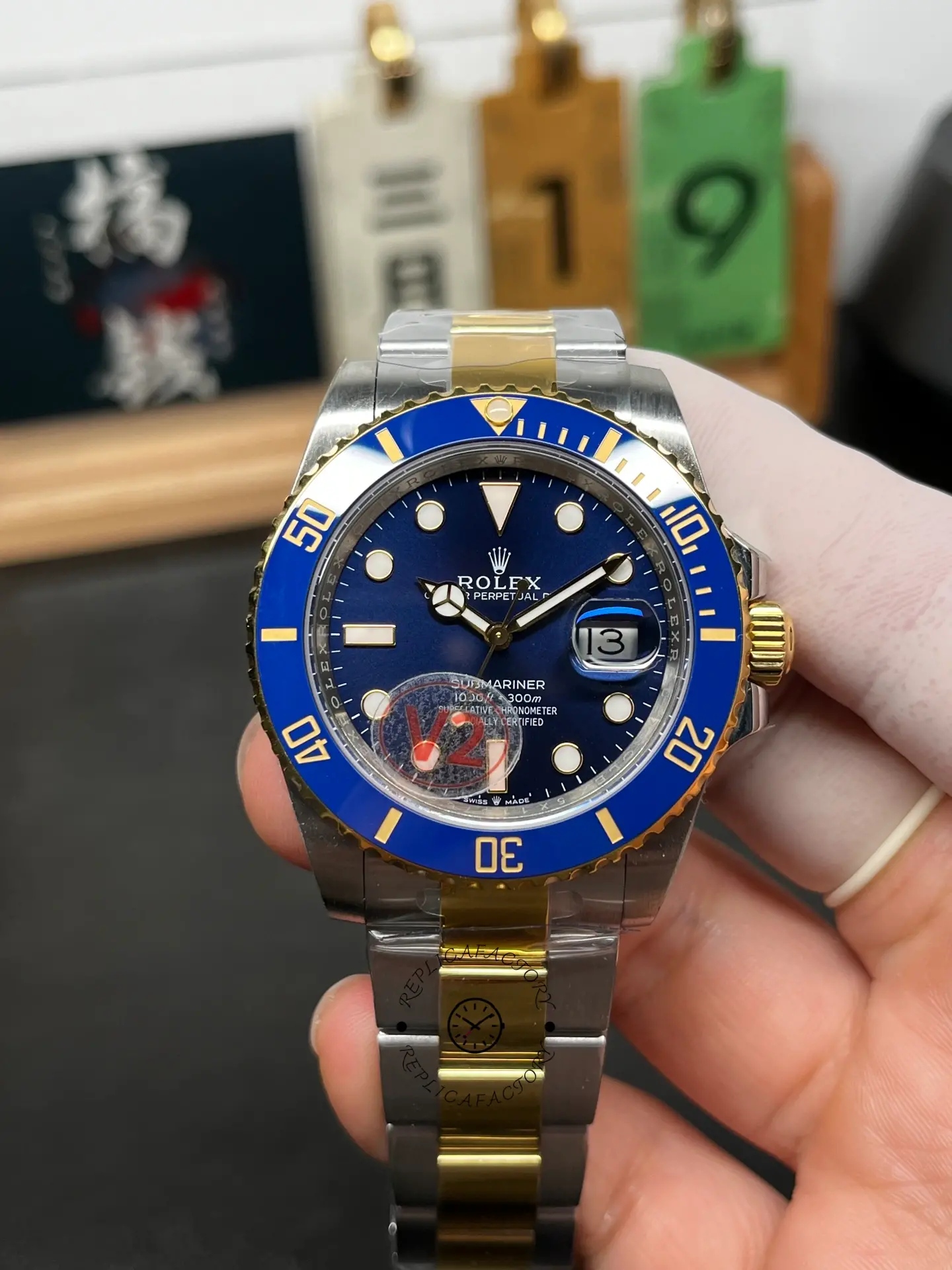 Front view of Rolex Submariner 126613LB with blue dial, blue bezel, date window, and two-tone Oyster bracelet.