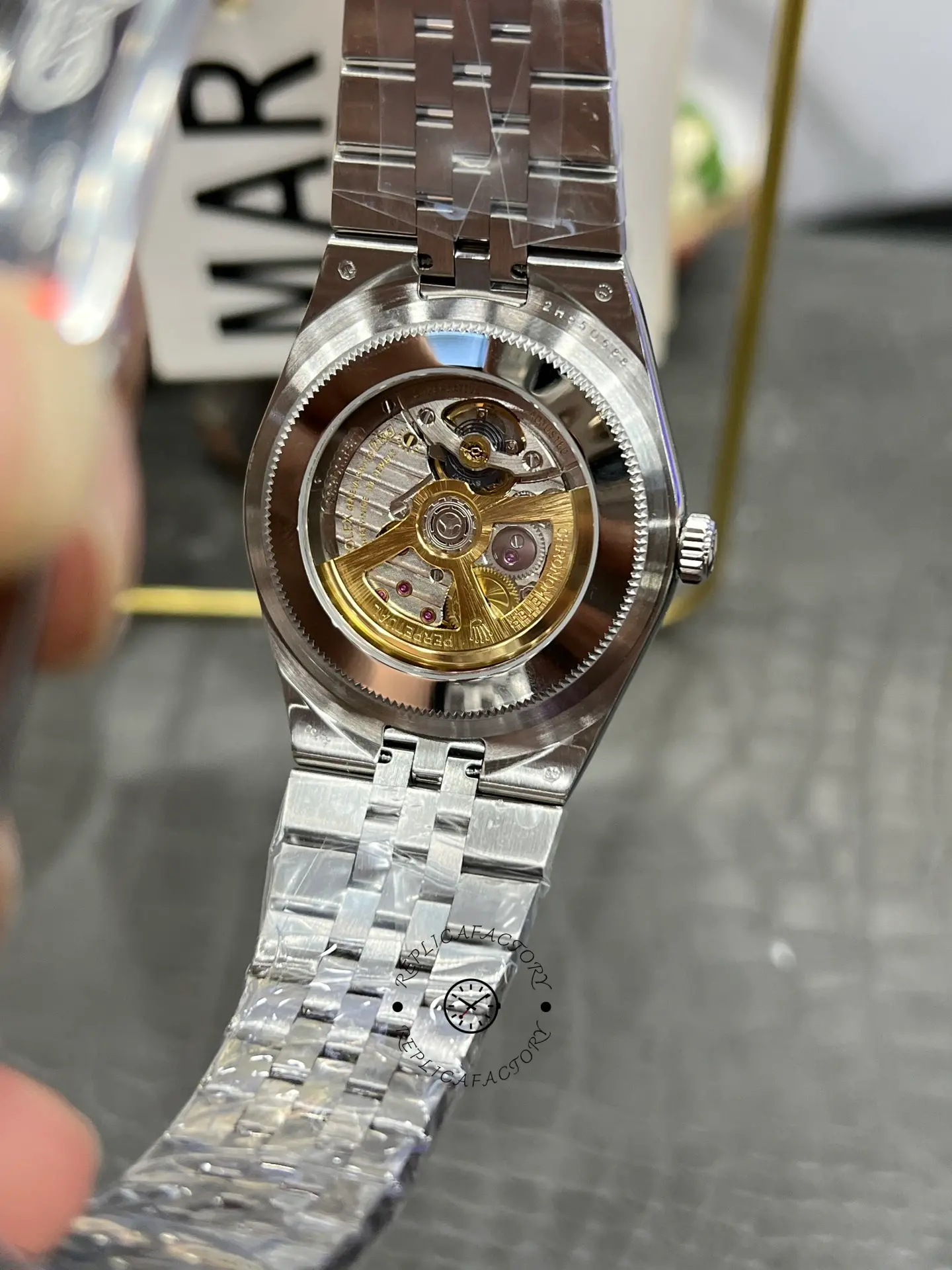 Back view of Rolex Land-Dweller 40 M127334-0001 replica showing exhibition case back and automatic rotor.
