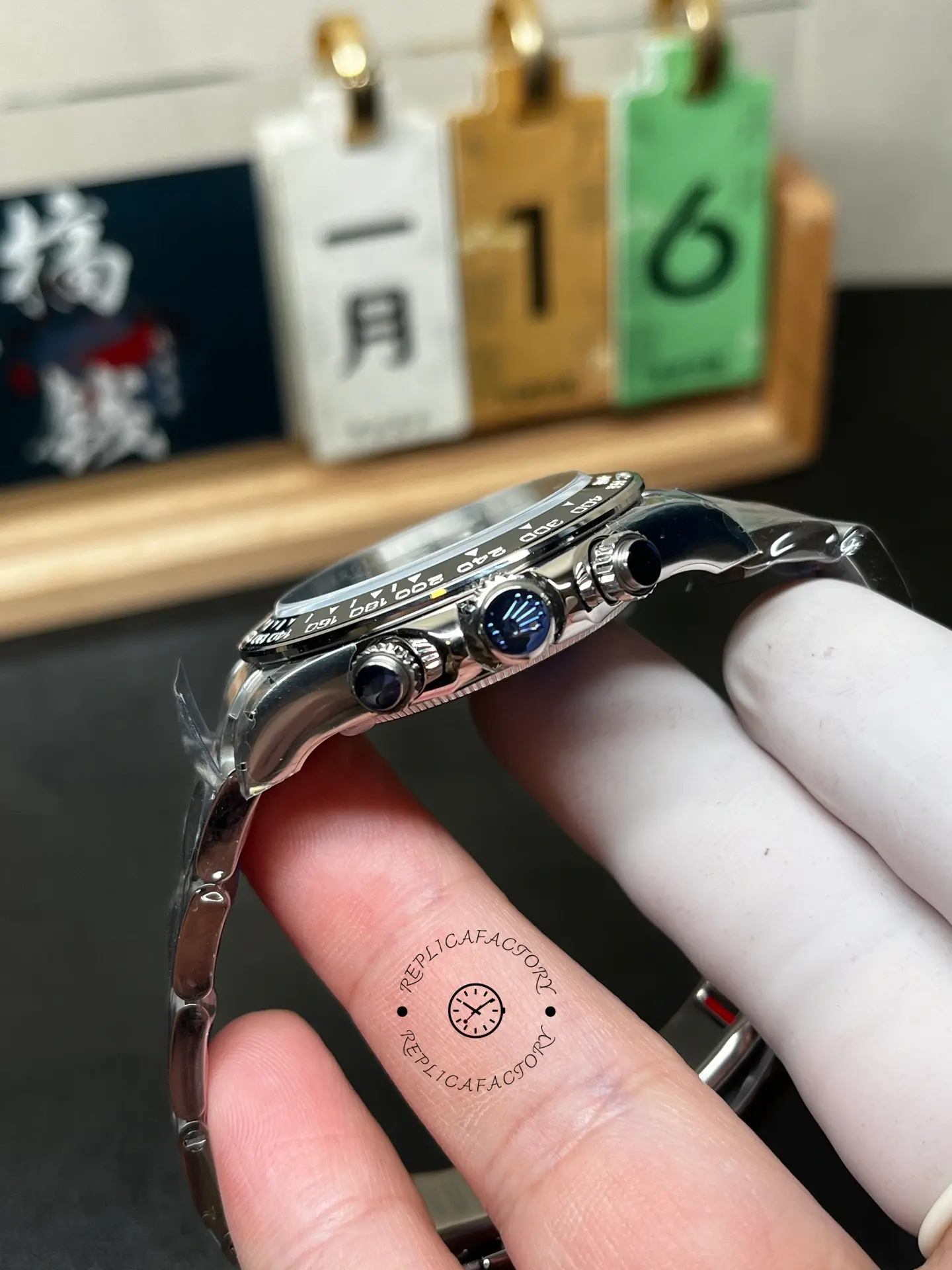 Side view of Rolex m126500ln-0002 showing crown, chronograph pushers and ceramic bezel edge.