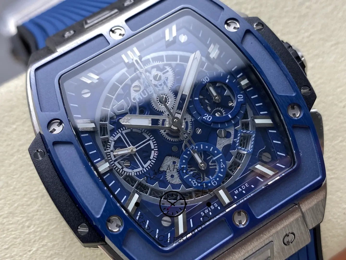 Front close-up of Hublot 642.NL.7170.RX showing blue bezel, skeleton chronograph, and angled date.