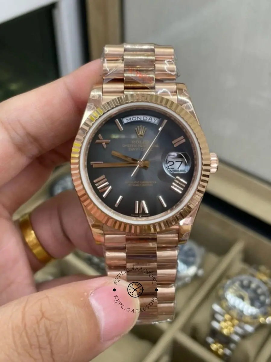 Handheld close-up of Rolex Day-Date 40 M228235-0055 highlighting the fluted bezel and dark dial.