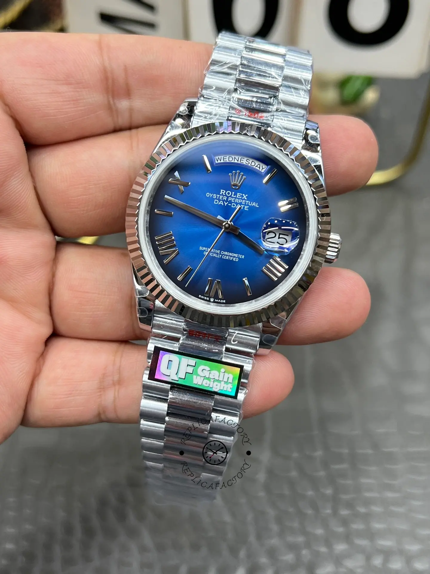 Close front-right view of Rolex Day-Date 228239-0076 showing Roman numerals and blue ombré dial gradient.