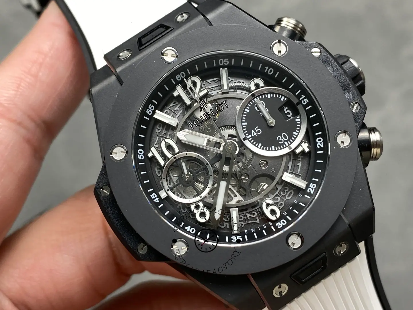 Close-up of Hublot Big Bang Unico 441.CI.1171.RX showing skeleton dial, black bezel screws and subdials.