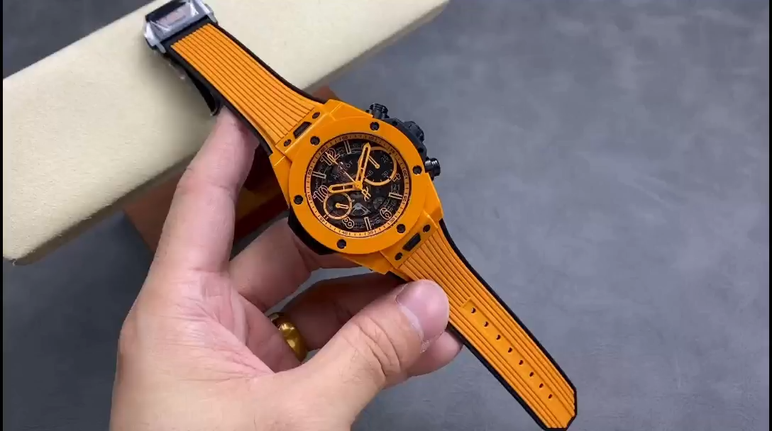 Strap and buckle detail of Hublot Big Bang Unico 441.CU.5910.RX, orange rubber strap held in hand. - Video