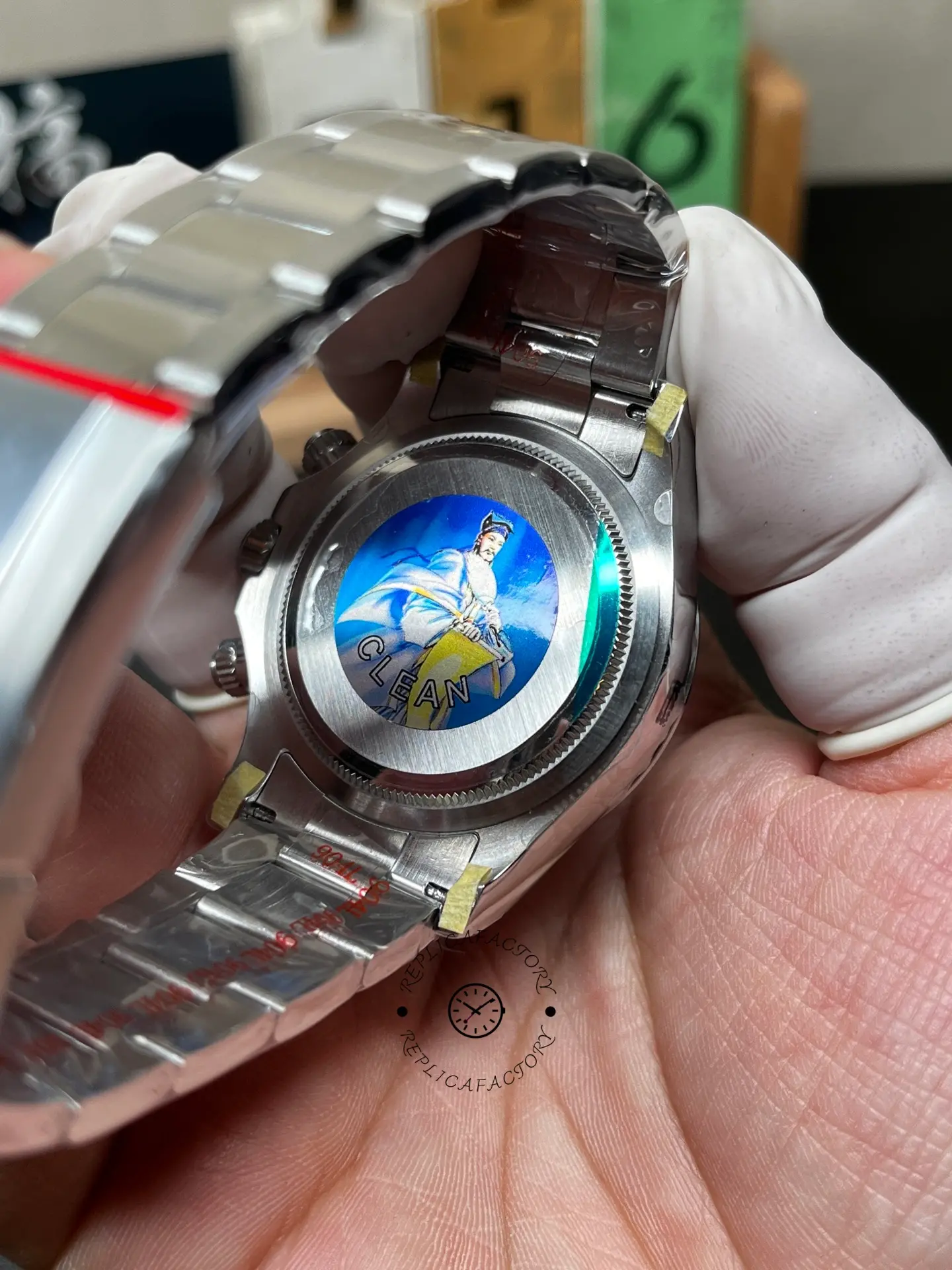 Caseback view of Rolex m126500ln-0002 with opened bracelet and protective sticker.