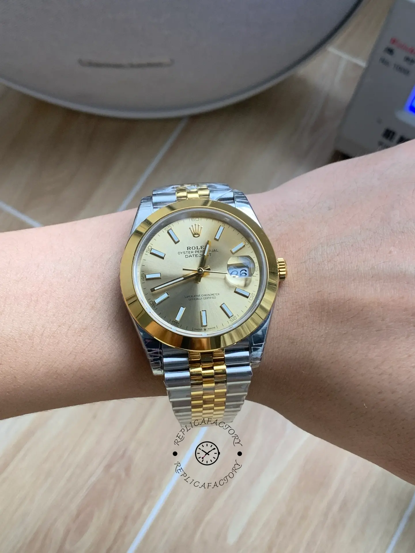 Wrist shot of Rolex Datejust 41 126303-0010 showing champagne dial and two-tone Jubilee bracelet on wrist.