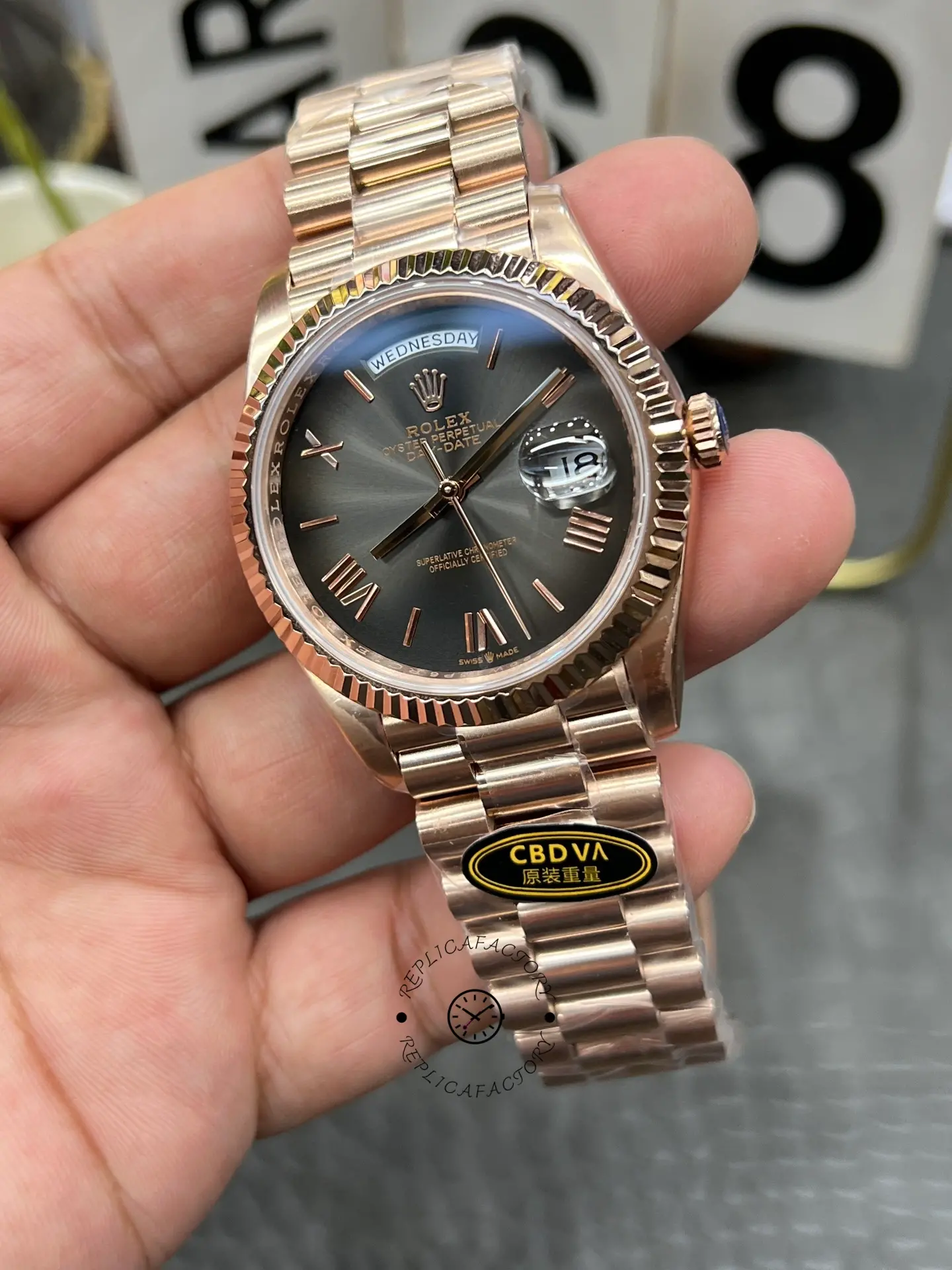 Front-right angle of Rolex Day-Date 40 M228235-0055 showing the fluted bezel, crown and dark dial finish.