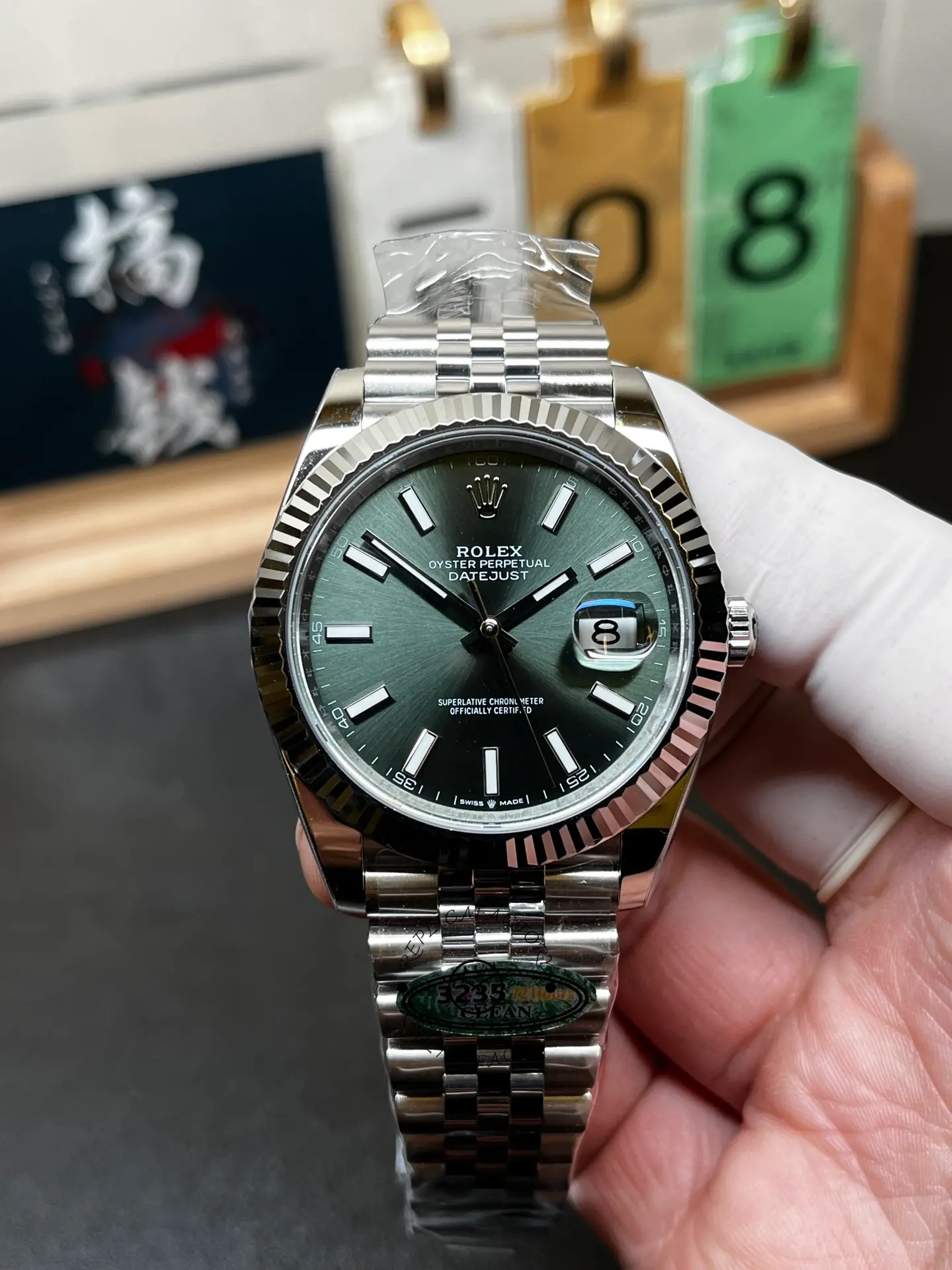 Front view of Rolex Datejust 126334-0028 showing green dial, fluted bezel, Jubilee bracelet and date window.