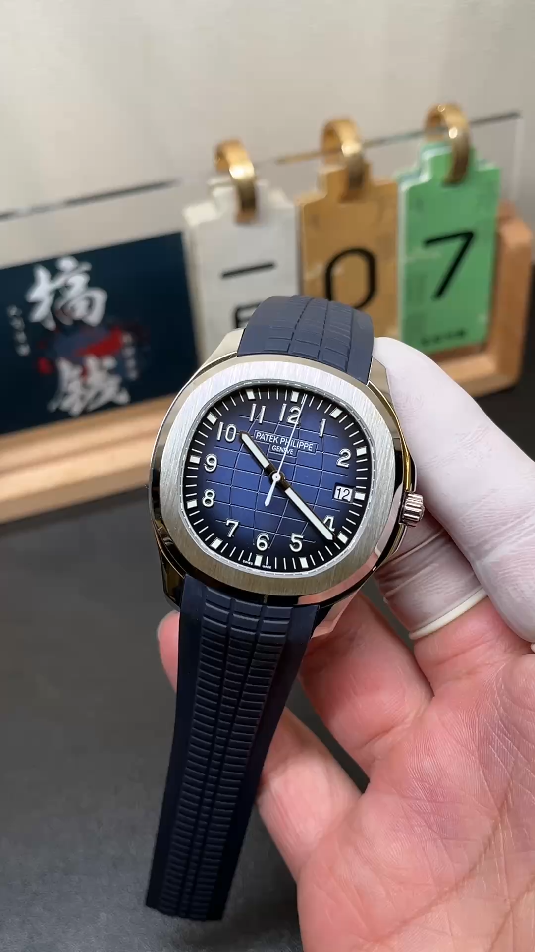 Video: hand-held Patek Philippe Aquanaut 5168G-001 showing blue strap texture and case polish. - Video