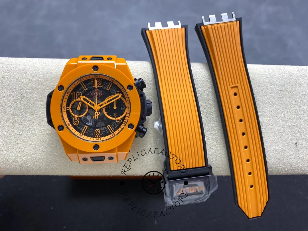 Watch with detached strap pieces: Hublot 441.CU.5910.RX orange ceramic case beside orange rubber strap components.