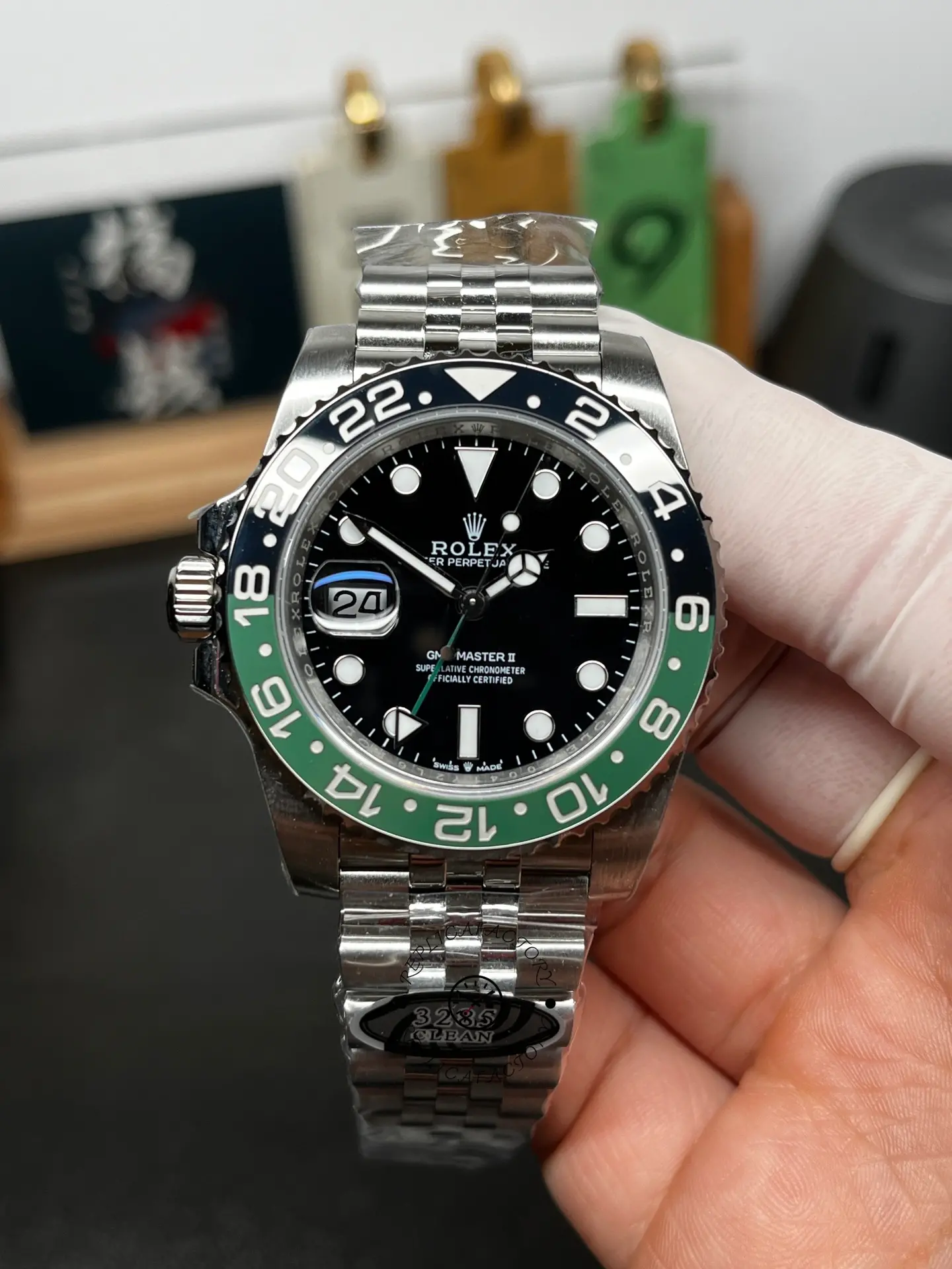 Front view of Rolex GMT-Master II 126720VTNR with black dial, green and black bezel, and Jubilee bracelet.