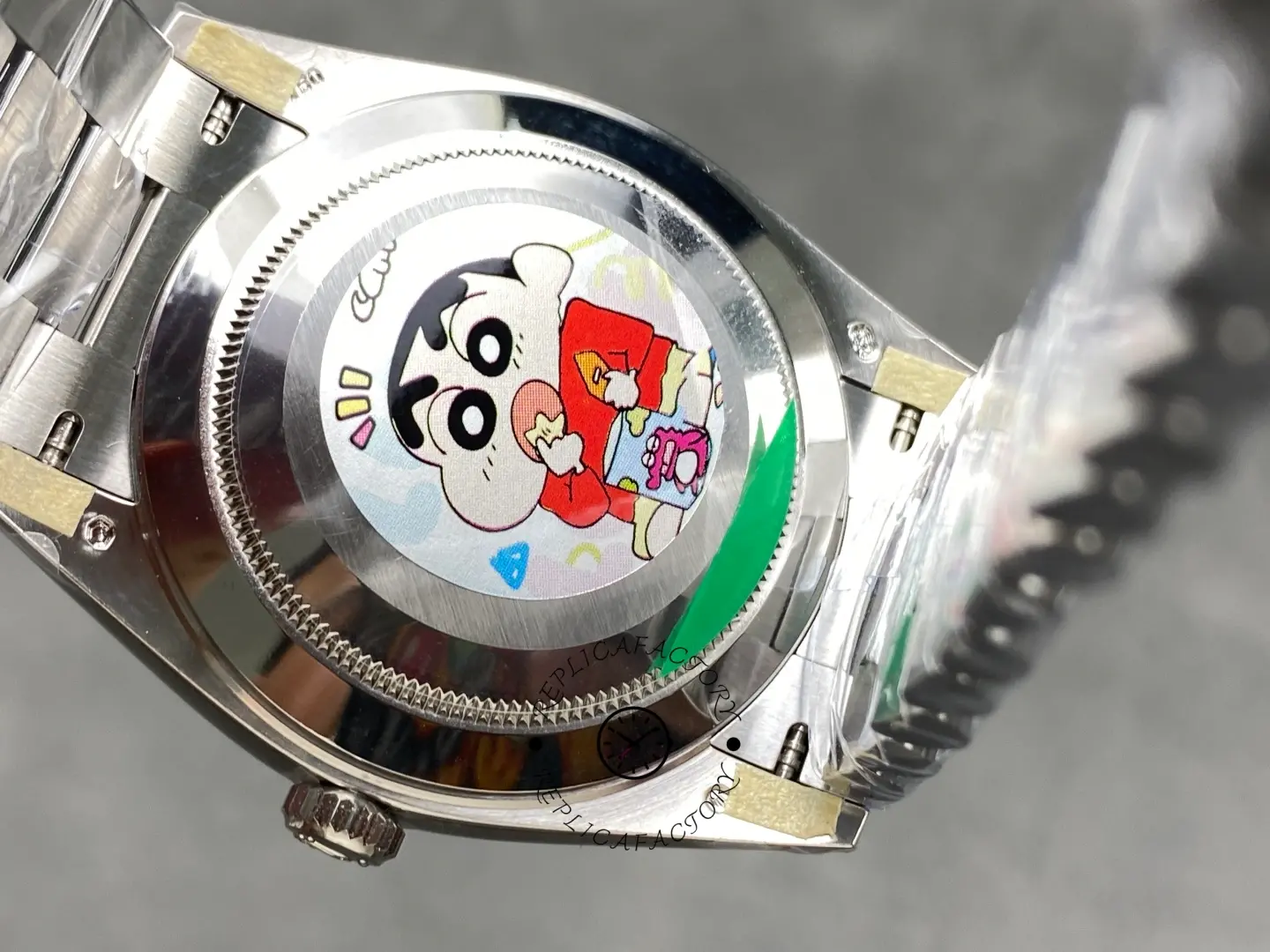Rolex Day-Date 228239-0076 caseback view with protective sticker and opened bracelet