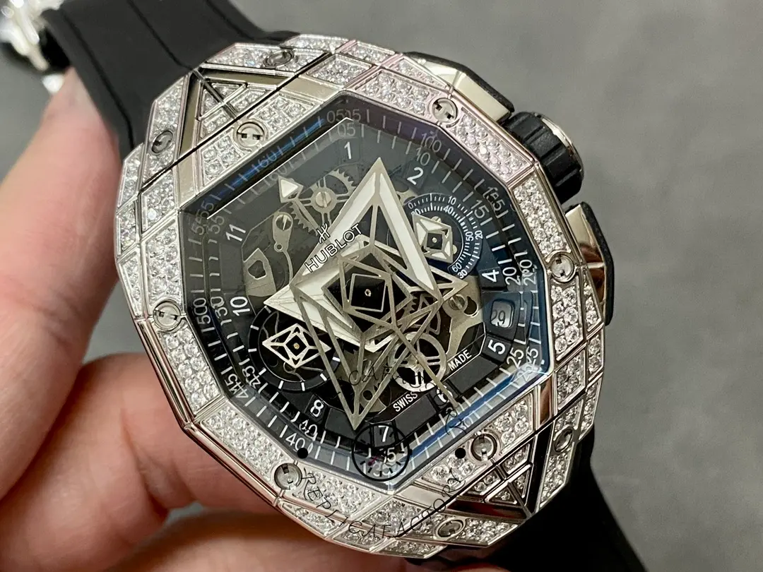 Angled view of Hublot 648.NX.0107.RX.1604.MXM23 highlighting diamond-style bezel setting and faceted case edges.