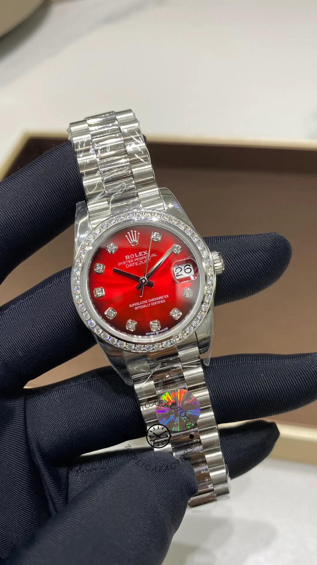 Front wristwatch view of Rolex Datejust 31 278289RBR-0028 showing the red dial and date magnifier at 3 o'clock.