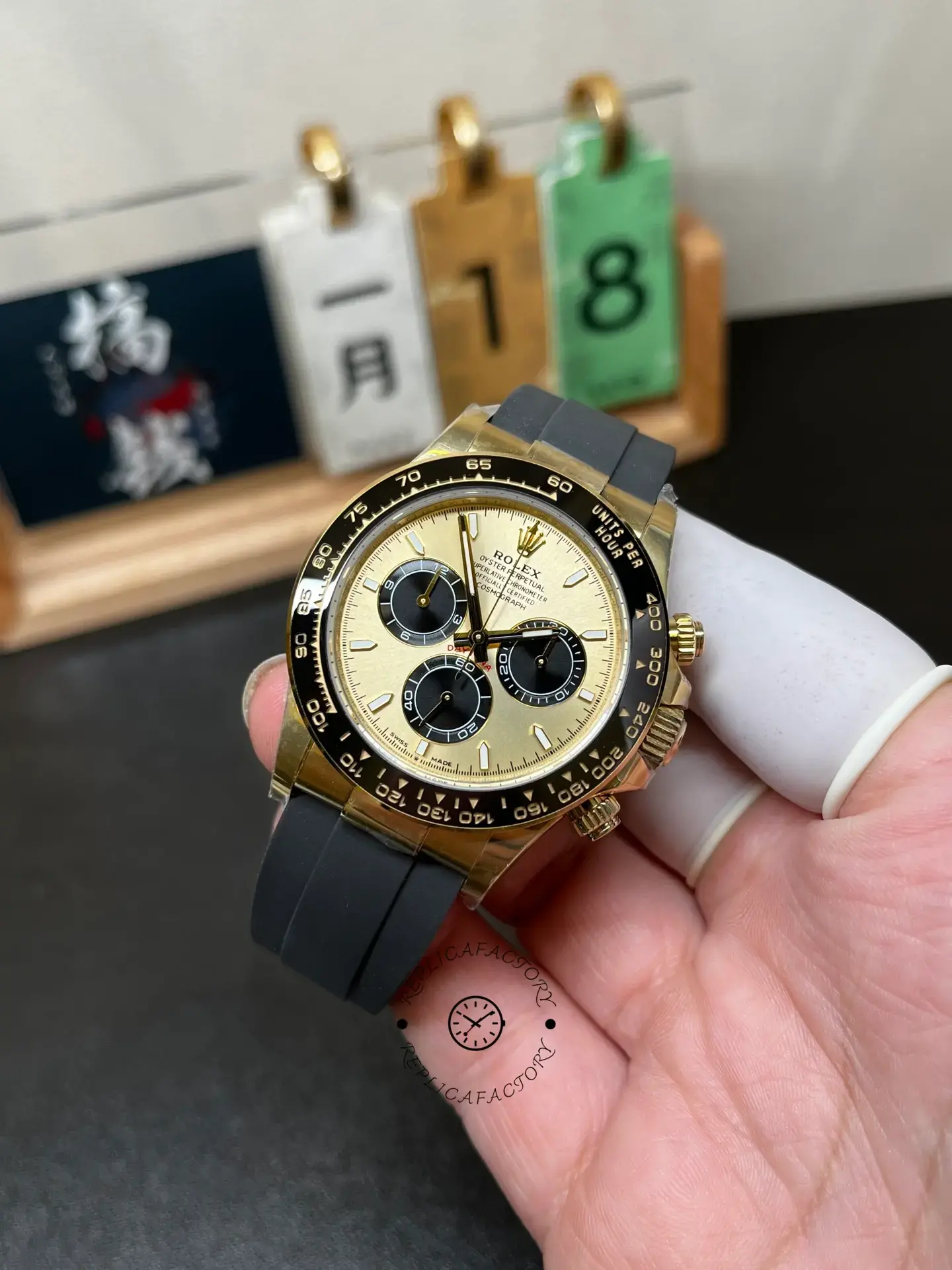 Handheld front angle of Rolex Daytona 126518LN-0012 showing dial layout and black sub-dials.