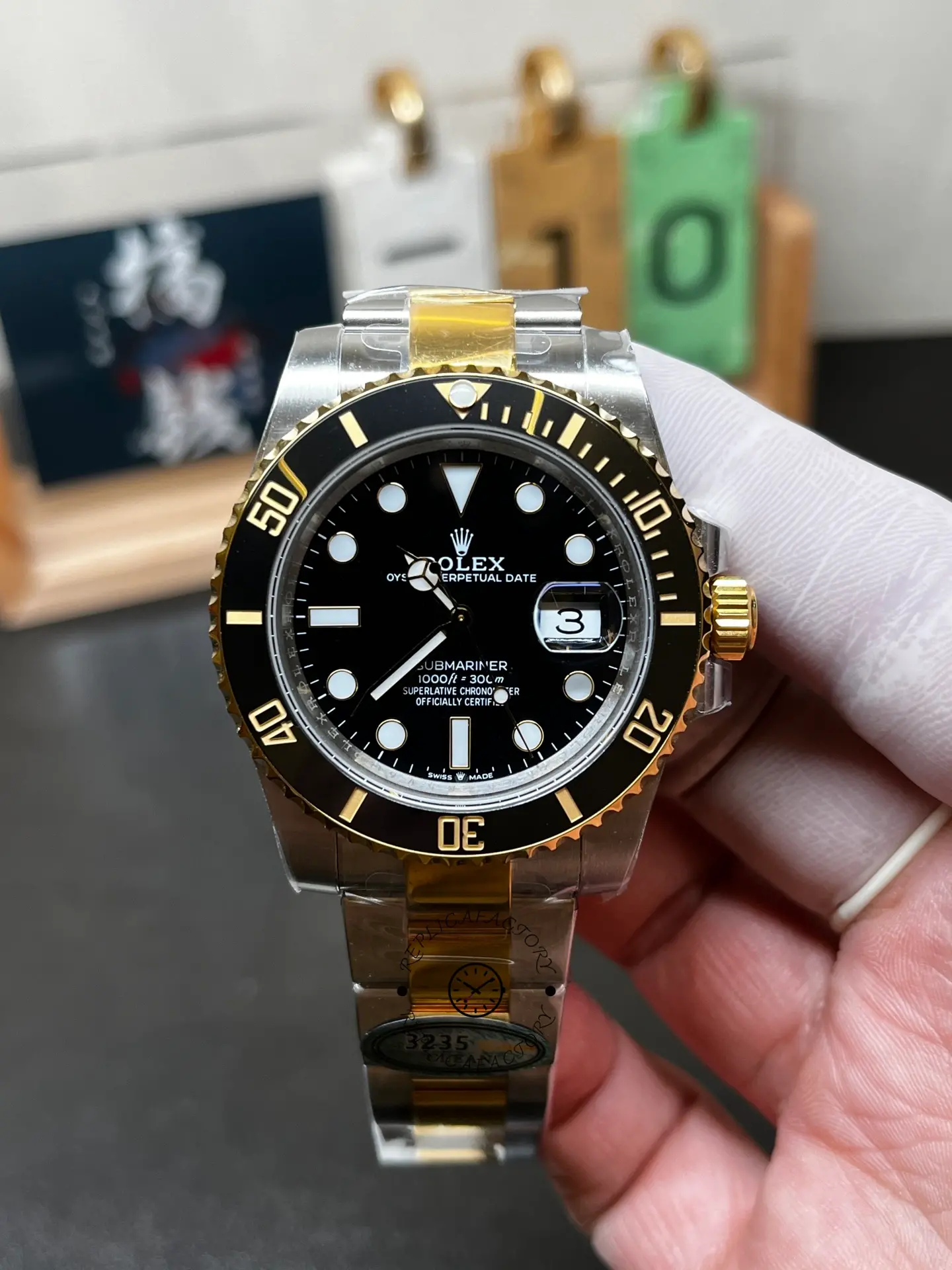 Front view of Rolex Submariner 126613LN-0002 replica with black dial, black bezel, date magnifier and two-tone bracelet.