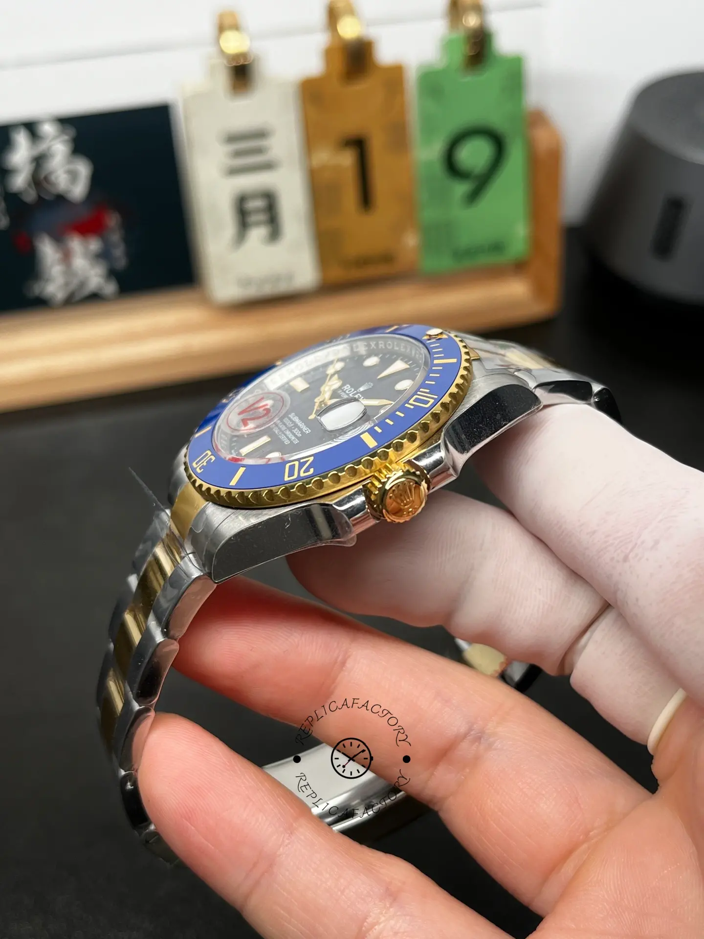 Side angle of Rolex Submariner 126613LB showing the blue bezel, gold crown, and case profile.