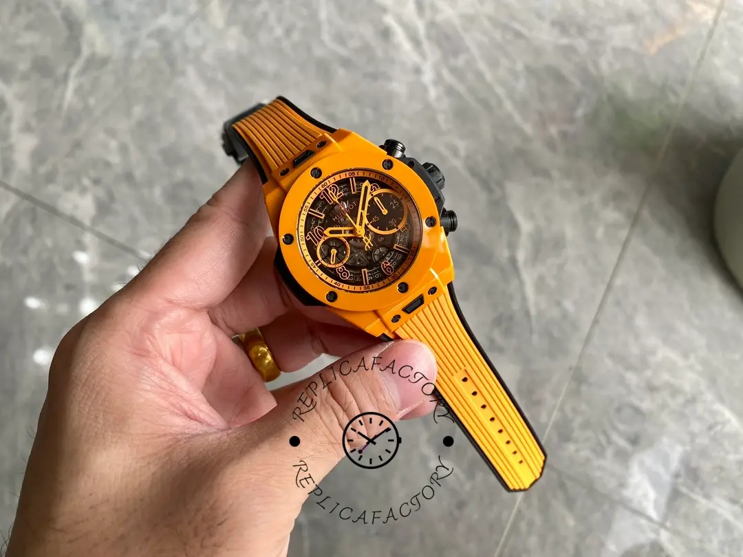 Full handheld shot of Hublot Big Bang Unico 441.CU.5910.RX showing orange strap and case proportions.