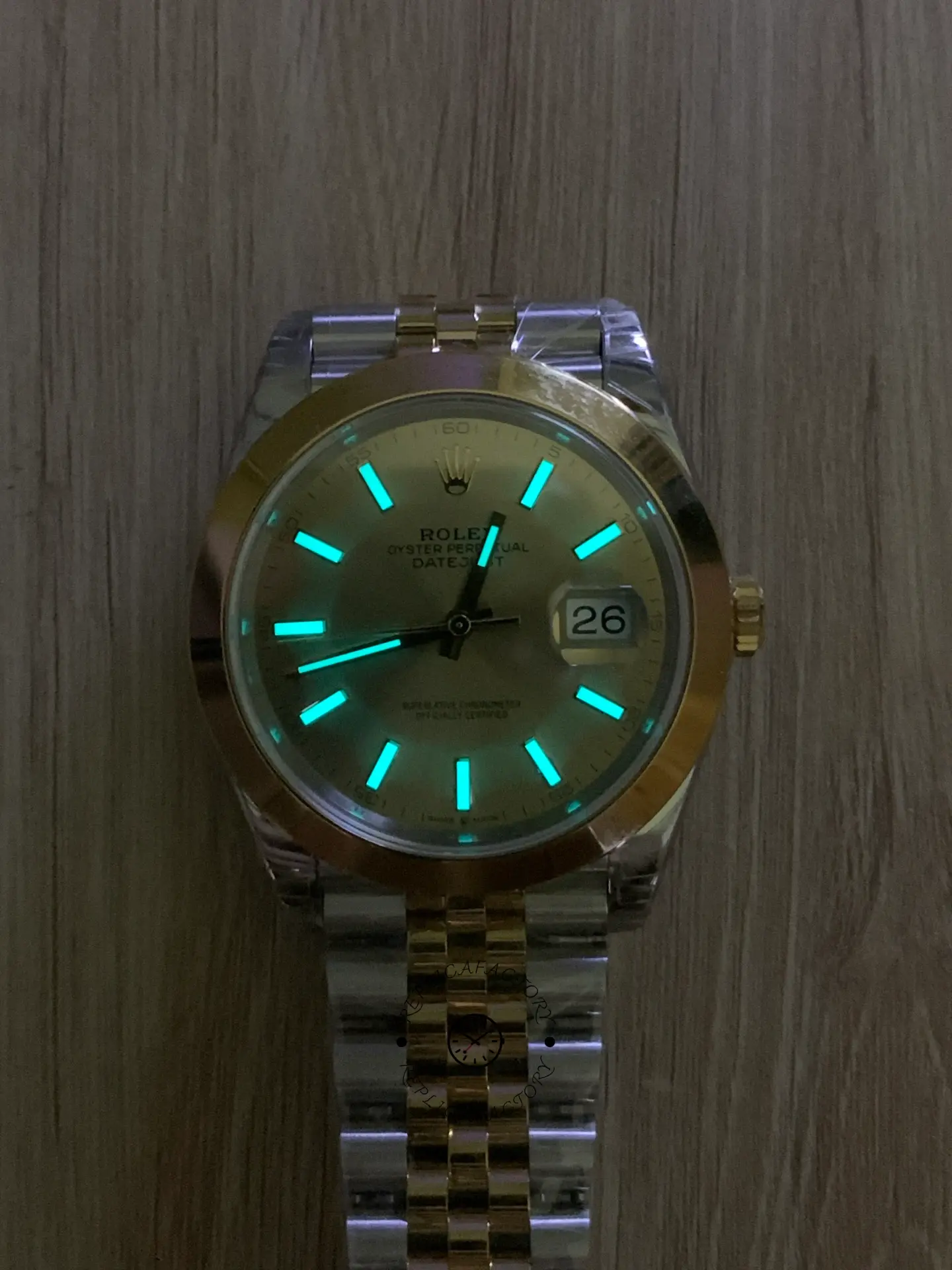 Low-light lume display of Rolex Datejust 41 126303-0010 showing glowing hands and hour markers.