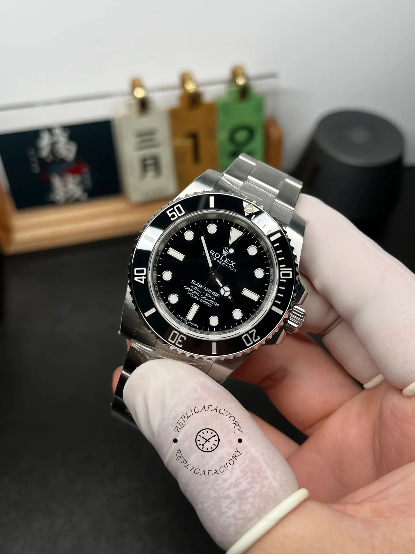 Angled front view of Rolex Submariner 124060 with black dial, black bezel, and Oyster bracelet in hand.