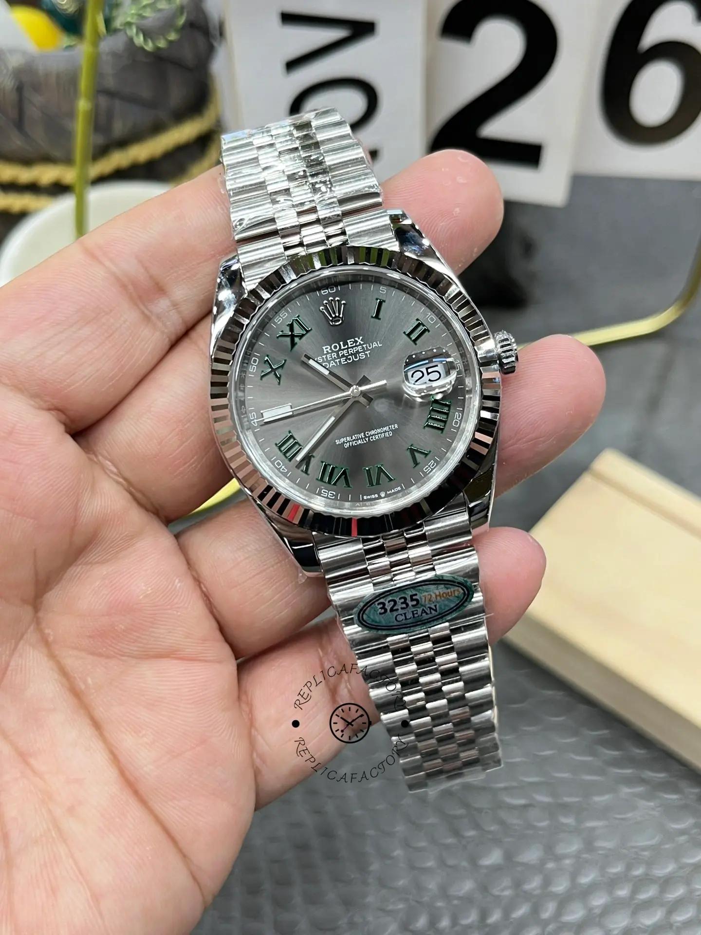 Handheld straight-on view of Rolex Datejust 126334-0022 showing the date magnifier and Jubilee bracelet.