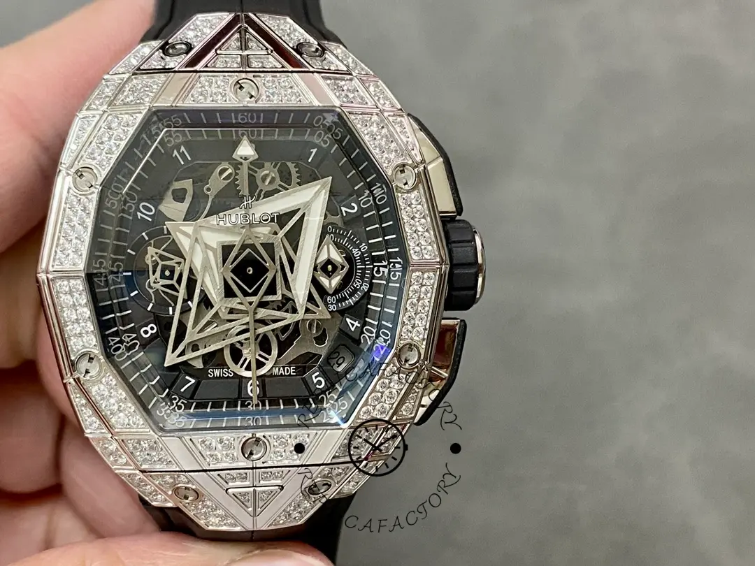 In-hand dial shot of Hublot 648.NX.0107.RX.1604.MXM23 showing minute track, skeleton depth, and bezel screws.