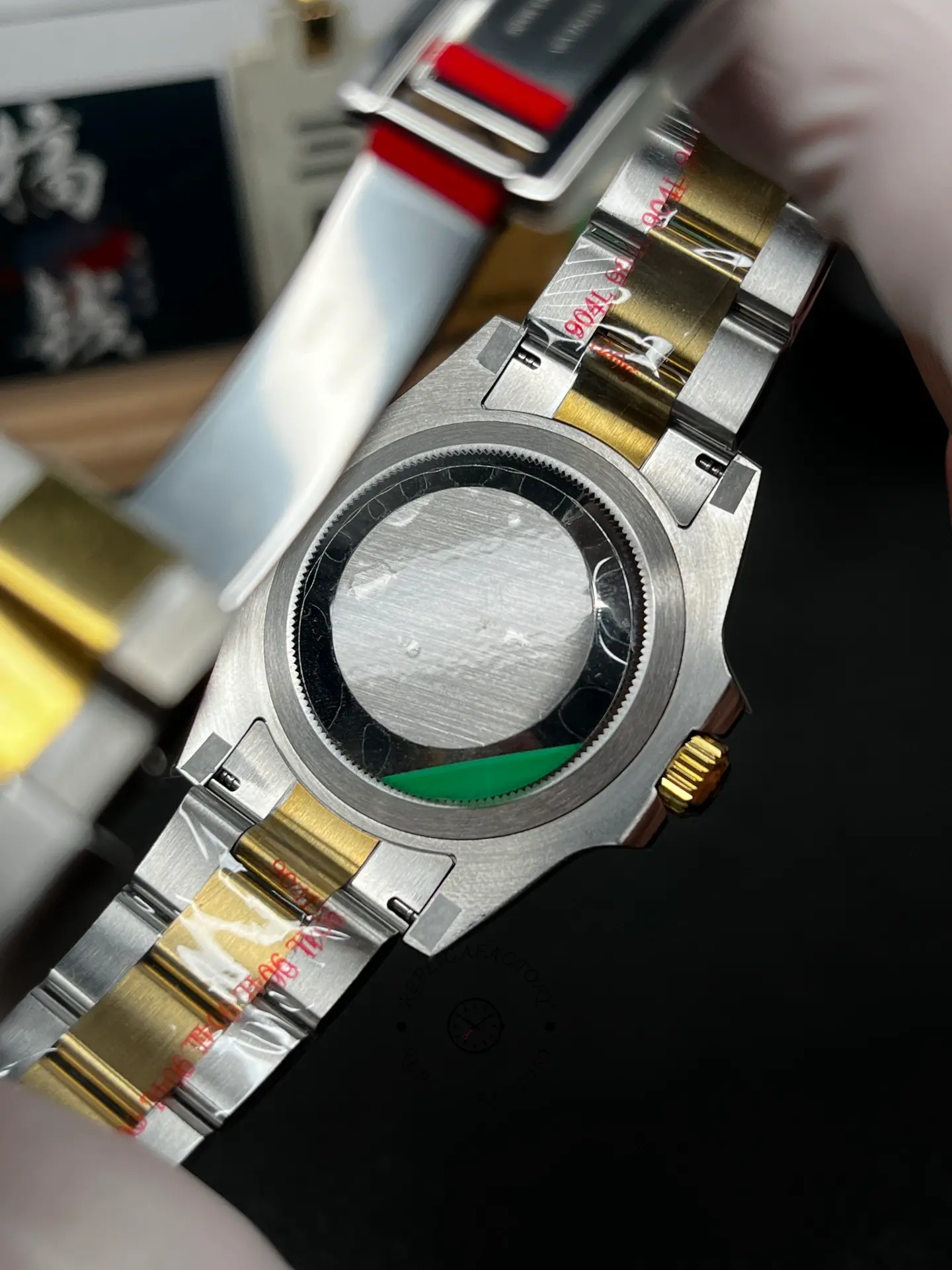 Rear view of Rolex Submariner 126613LB showing the solid case back and opened bracelet.