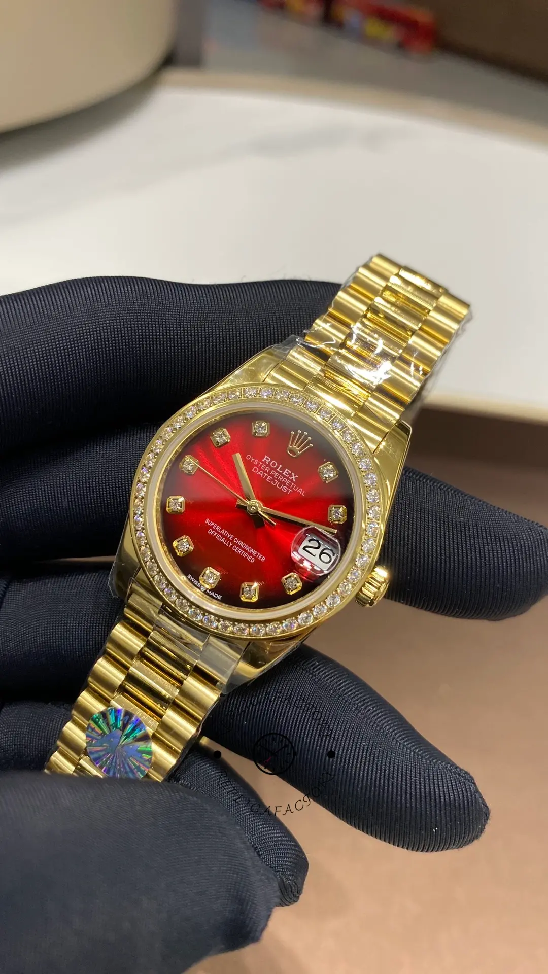 Angled front view of Rolex Datejust 31 278288RBR-0041 with red gradient dial and diamond-style hour markers.