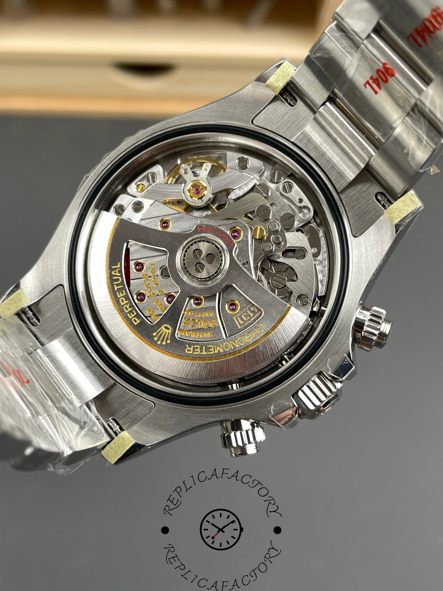 Open caseback view of Rolex Cosmograph Daytona m126500LN-0002 showing automatic movement.