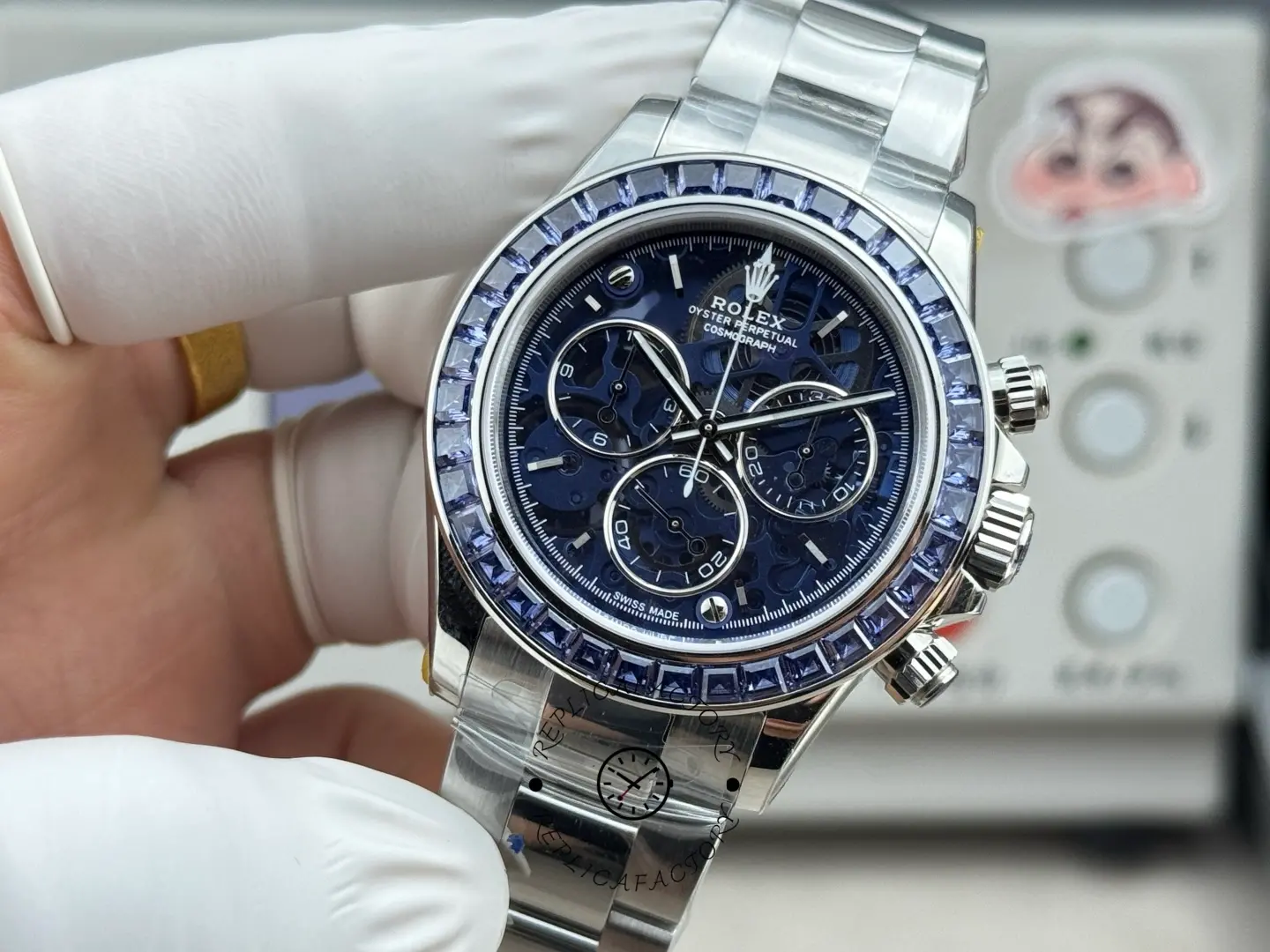 Angled front view of Rolex Daytona Arolla Glacier clear dial replica with Oyster bracelet and blue bezel.