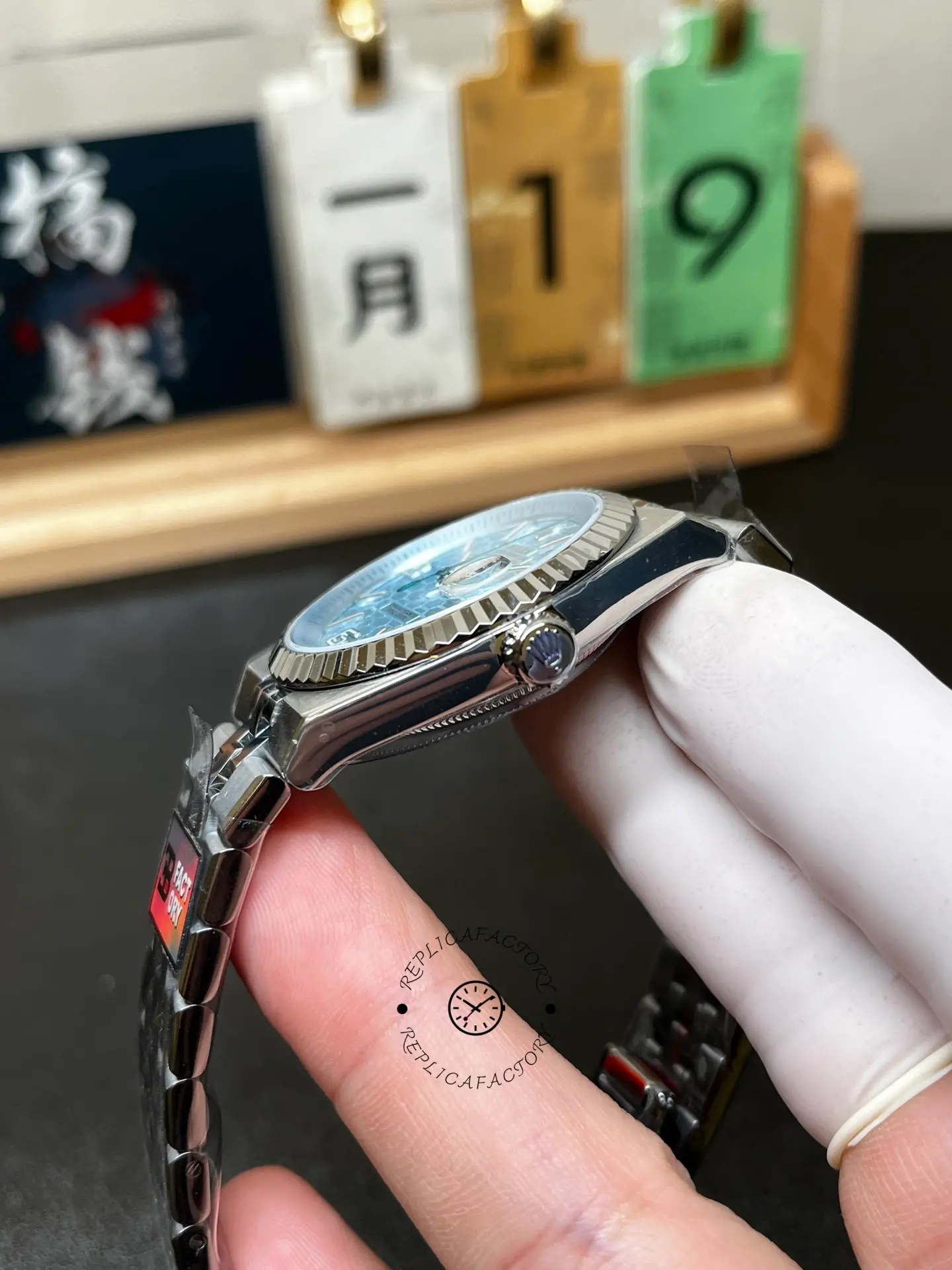 Side view of Rolex Land-Dweller 40 127336-0001 showing the crown, case profile and fluted bezel.