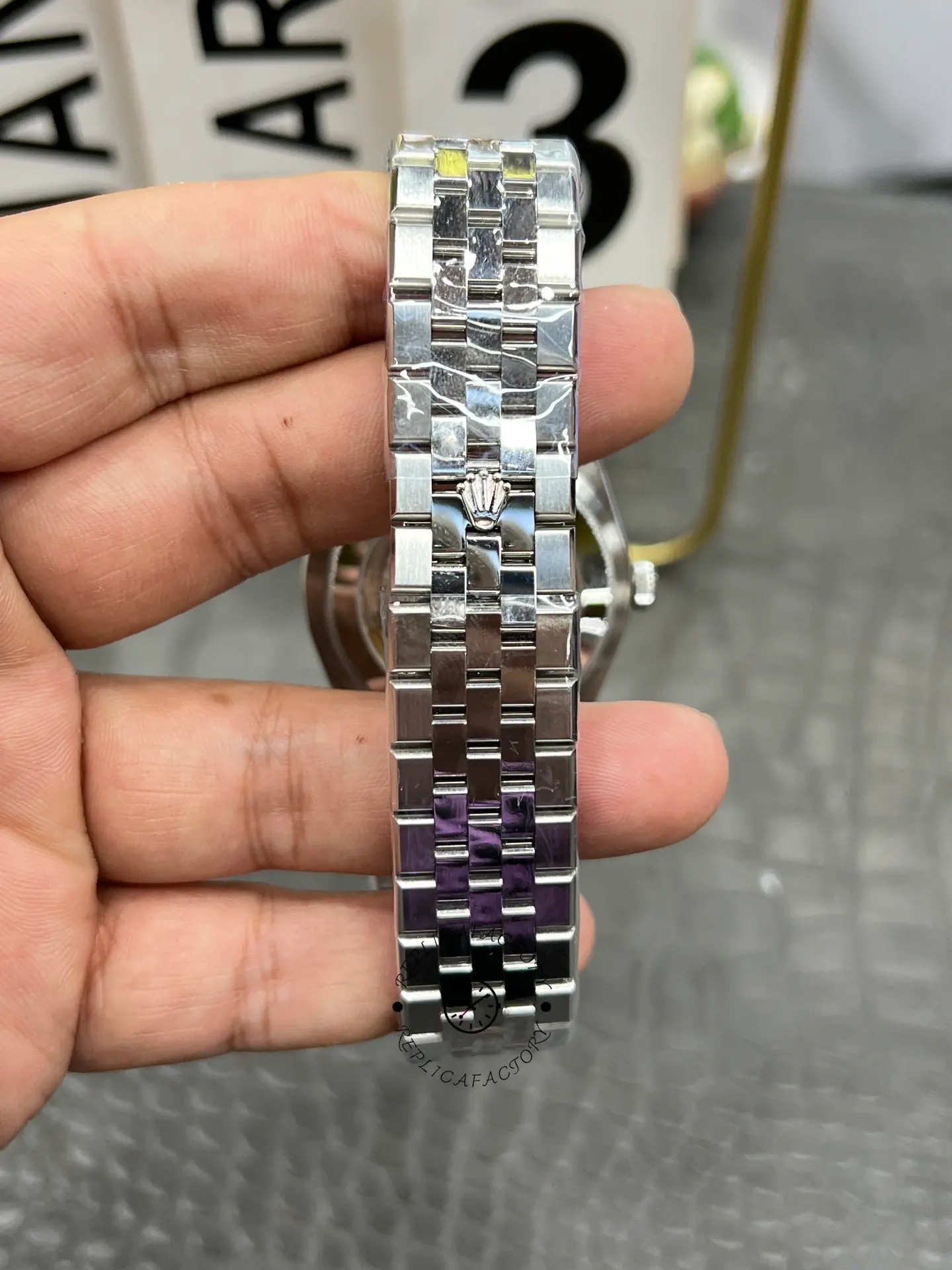 Bracelet close-up of Rolex Land-Dweller 40 M127334-0001 replica showing polished center links and crown clasp detail.