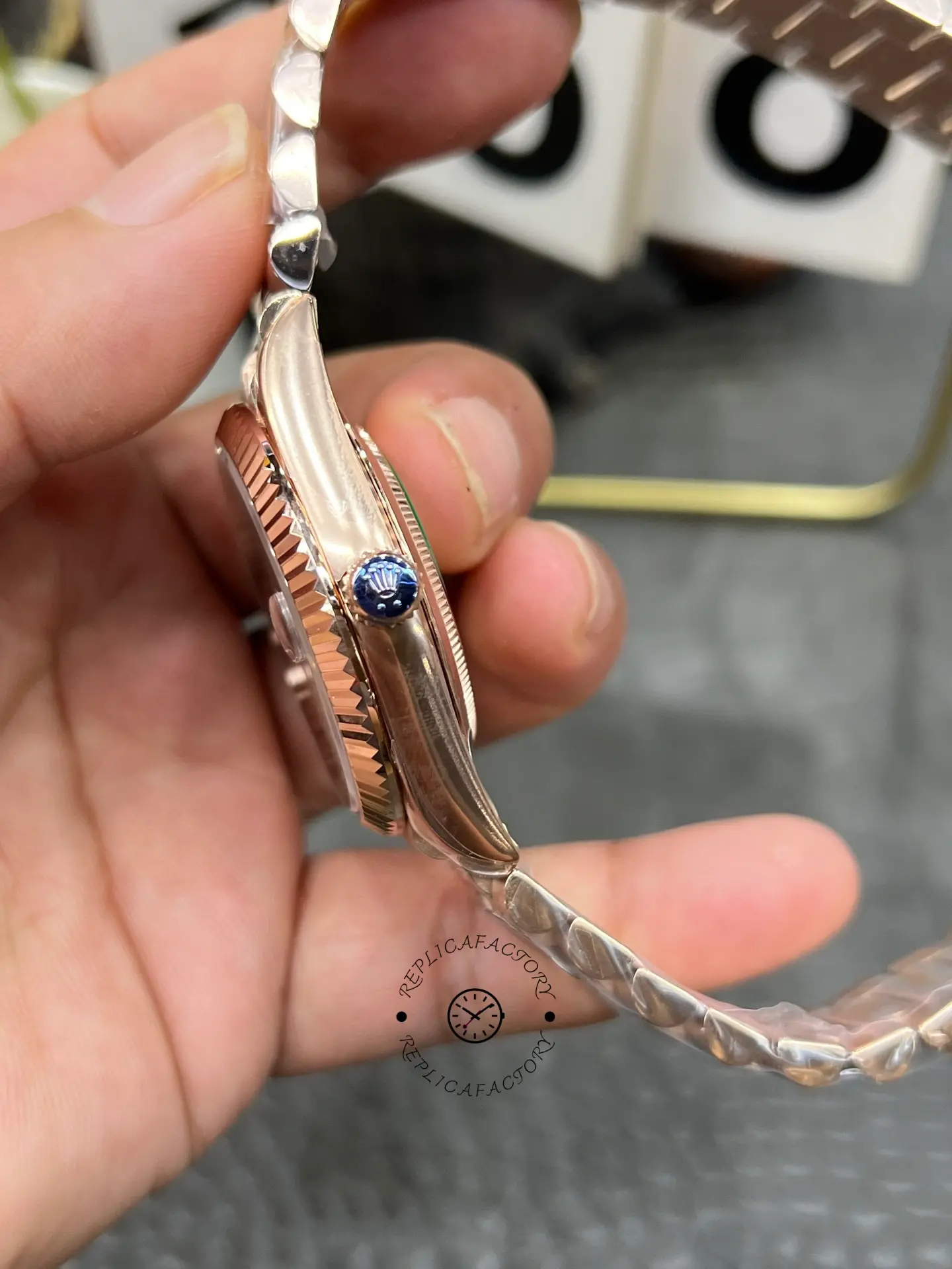 Side profile of Rolex Day-Date 40 M228235-0055 showing the case thickness, fluted bezel edge and blue crown cap.