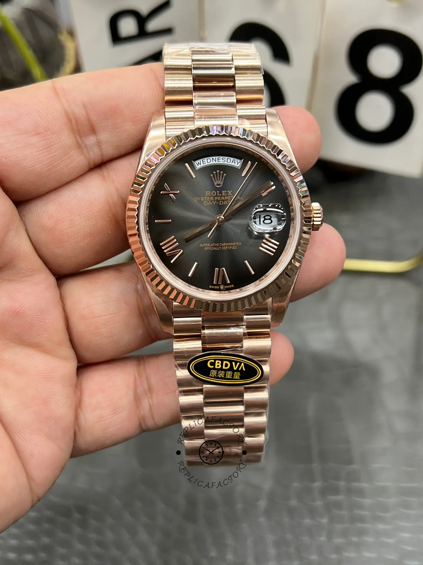 Front view of Rolex Day-Date 40 M228235-0055 with dark rhodium dial, fluted bezel and Everose gold-style bracelet.
