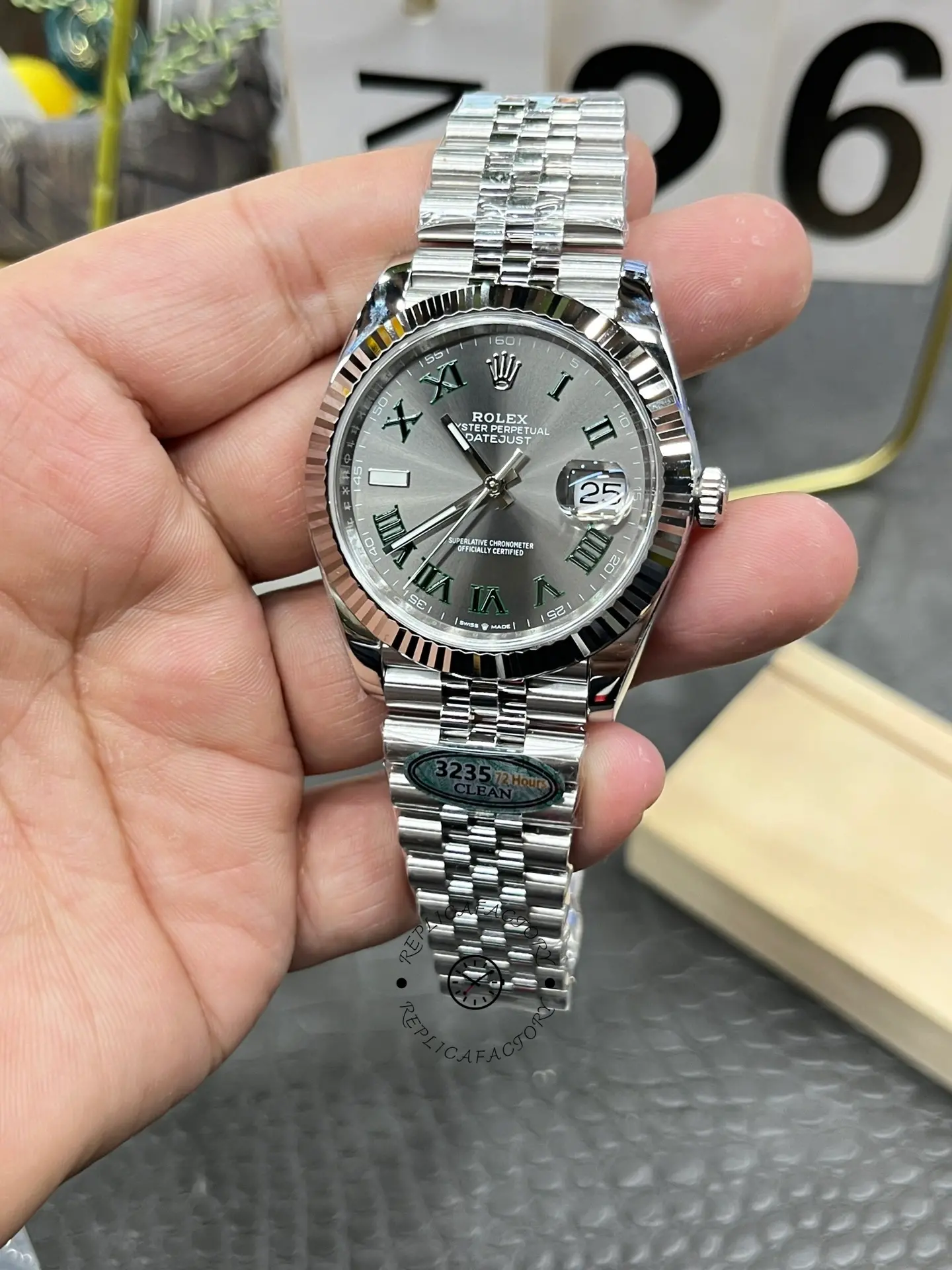 Handheld angled view of Rolex Datejust 126334-0022 with slate grey dial and fluted bezel.