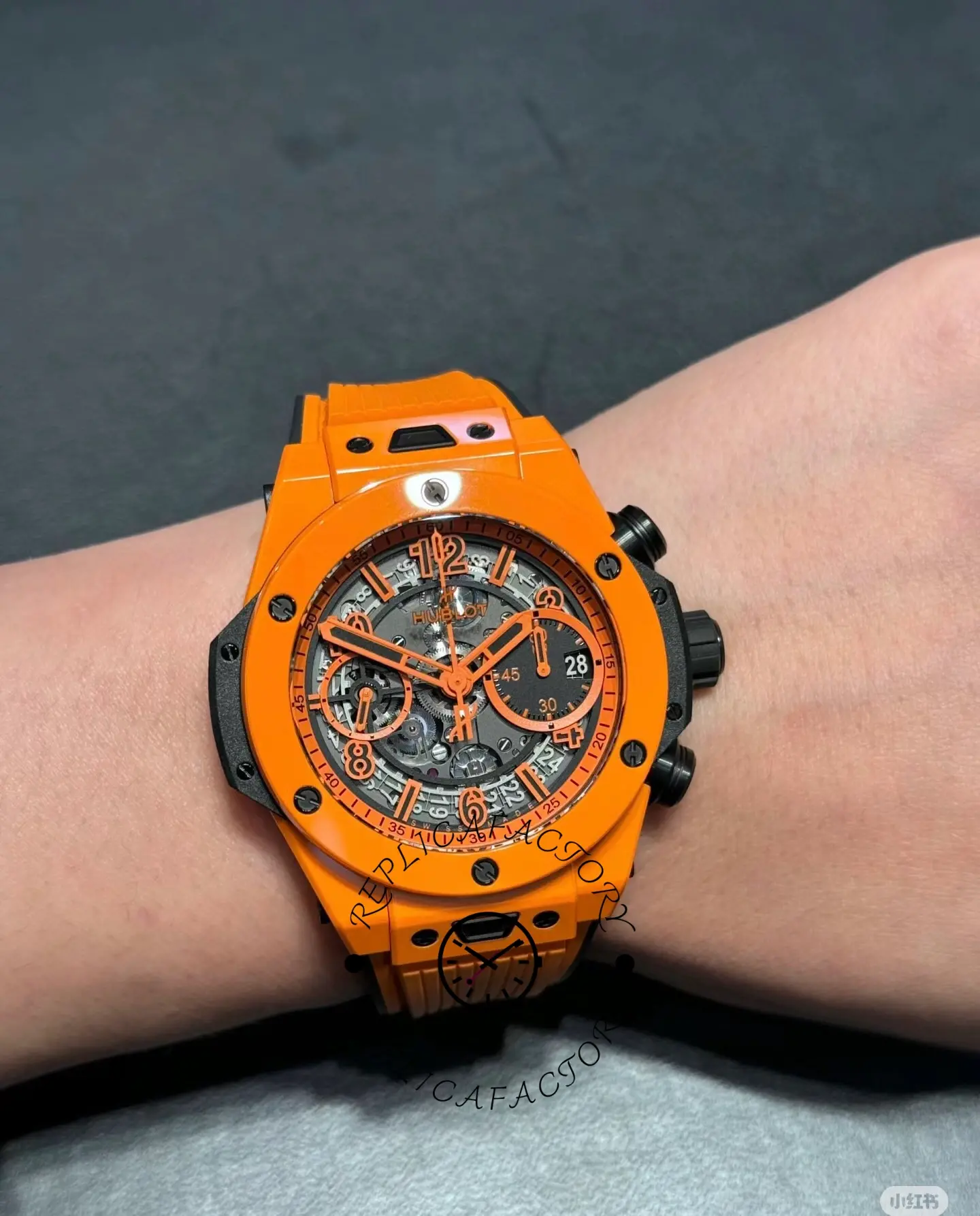 Wrist shot of Hublot Big Bang Unico 441.CU.5910.RX showing front dial view and orange strap.