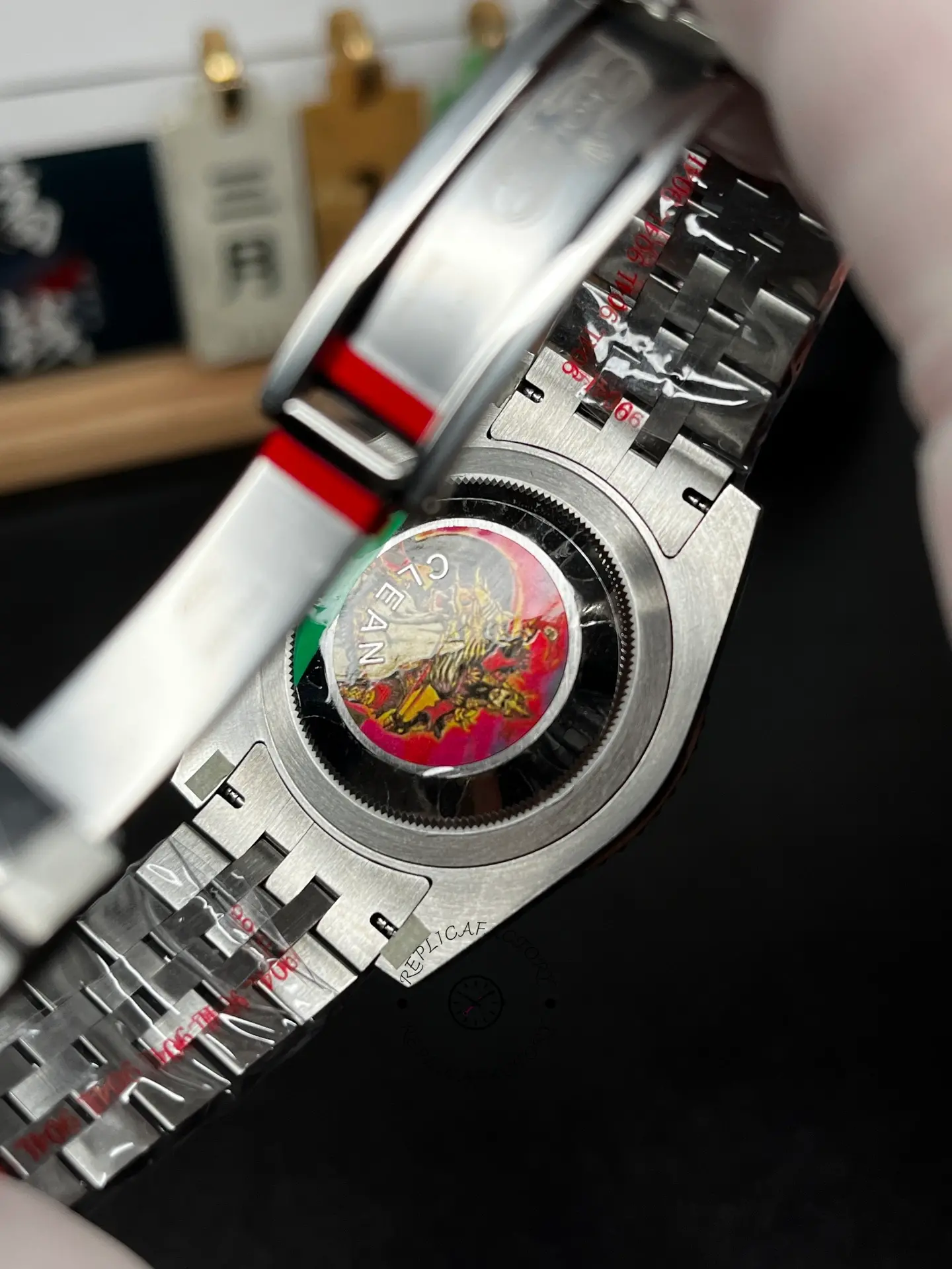 Caseback view of Rolex GMT-Master II 126720VTNR with bracelet interior and protective stickers visible.