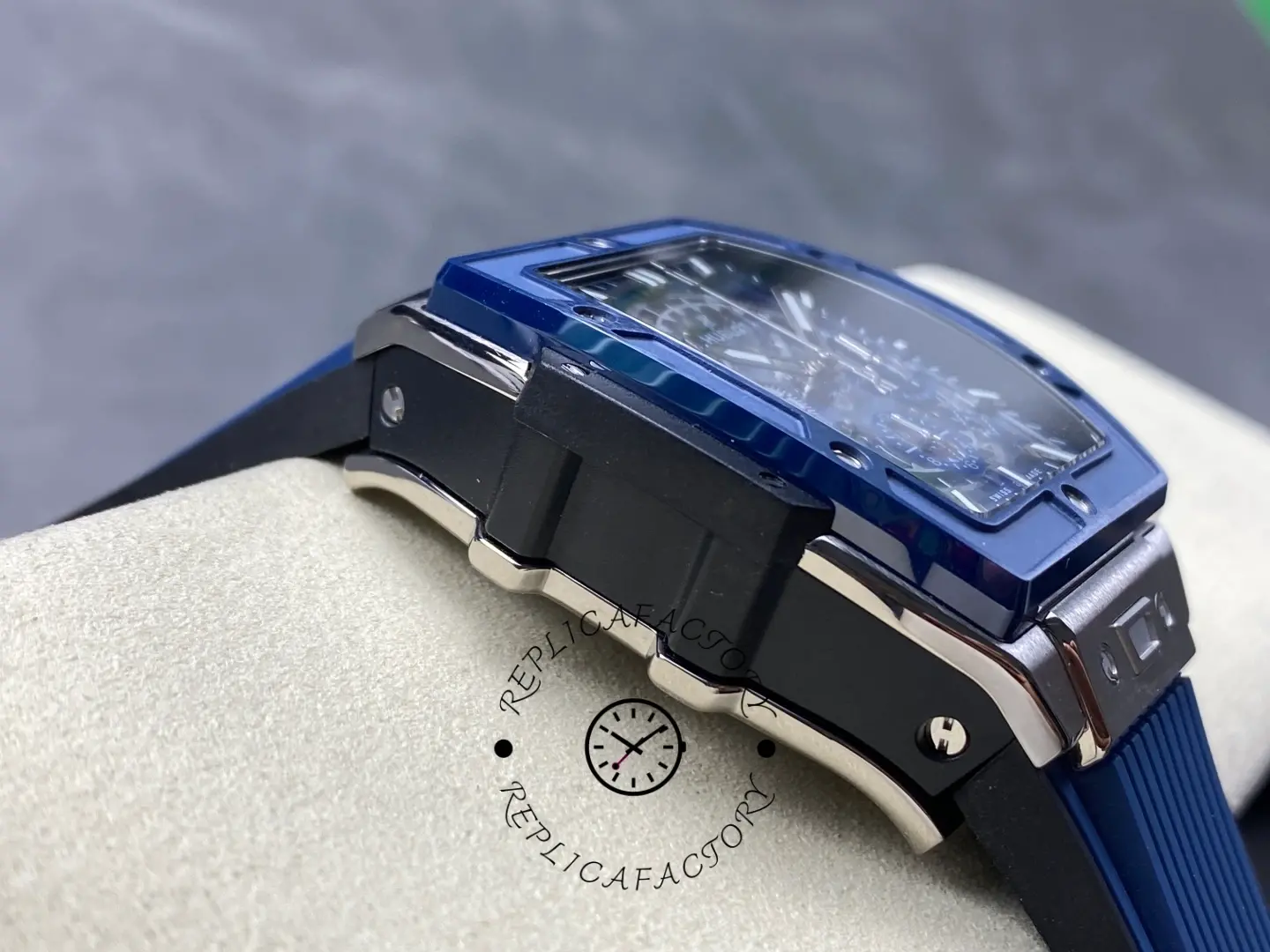 Angled wrist-pad shot of Hublot 642.NL.7170.RX showing blue bezel and blue rubber strap.