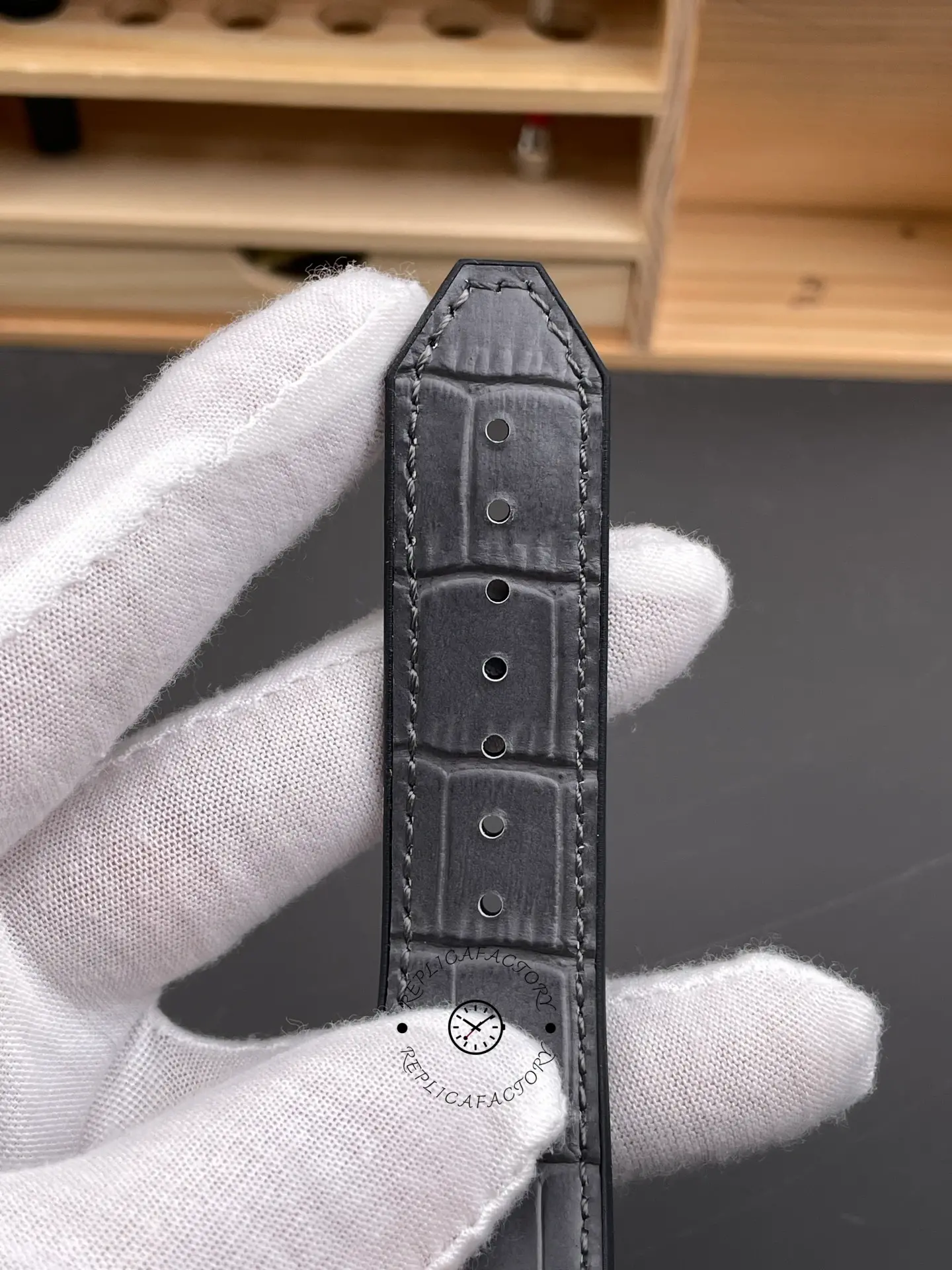 Close-up of strap tip on Hublot Classic Fusion King Gold 542.OX.1181.RX 42mm with grey leather texture.