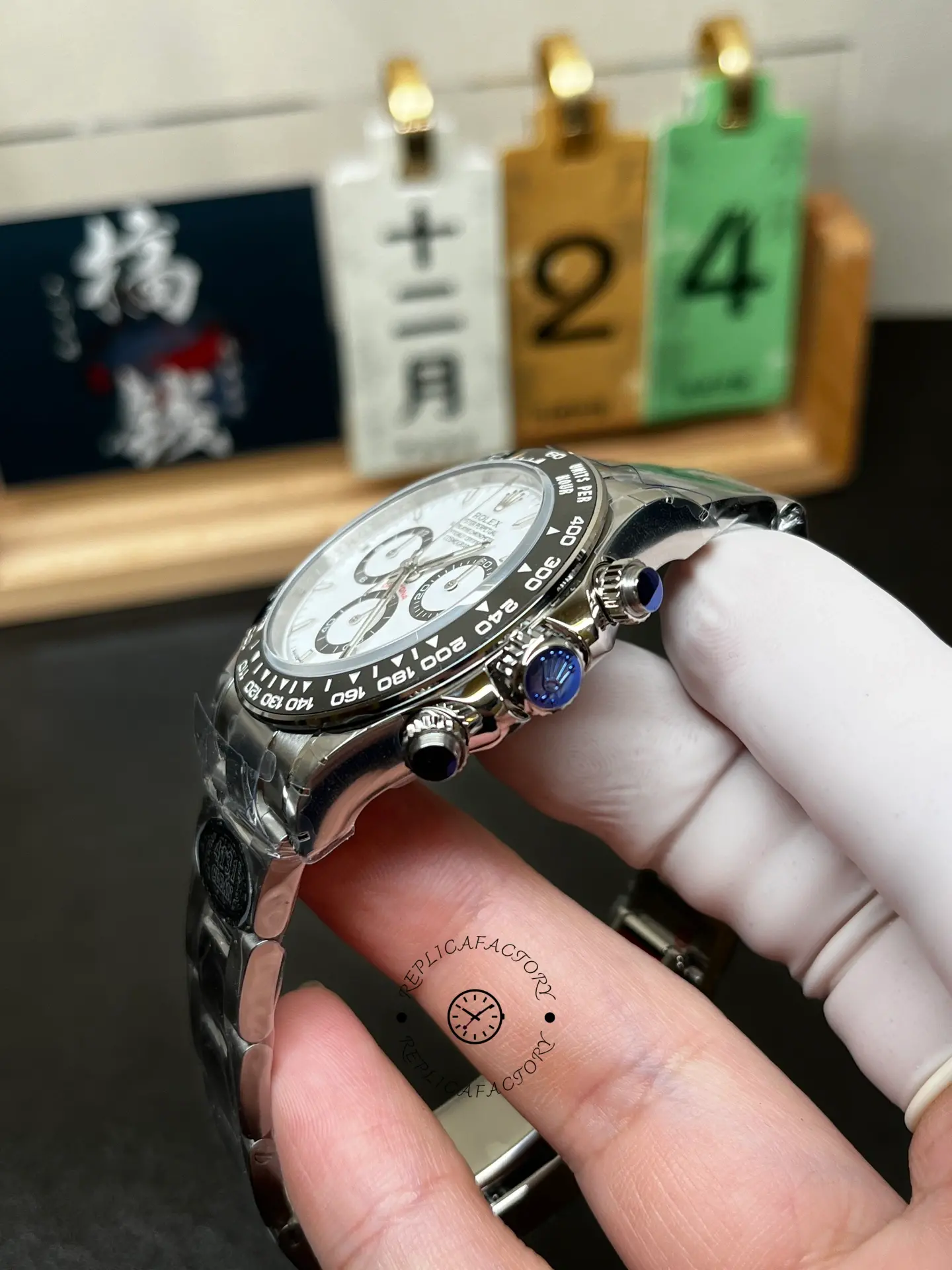 Side angle of Rolex Cosmograph Daytona M126500LN-0001 showing the crown, pushers and black bezel.