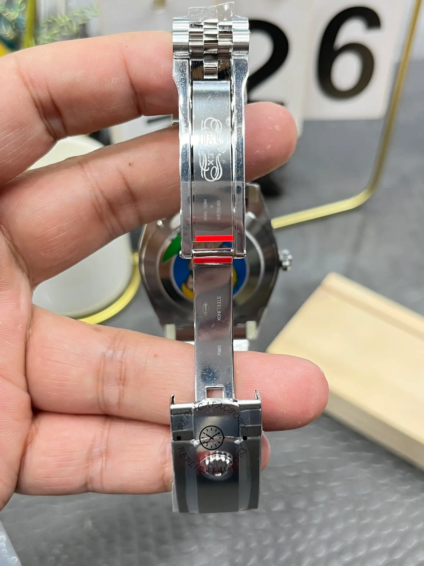 Open clasp interior view of Rolex Datejust 126334-0022 showing clasp engravings and steel folding blade.