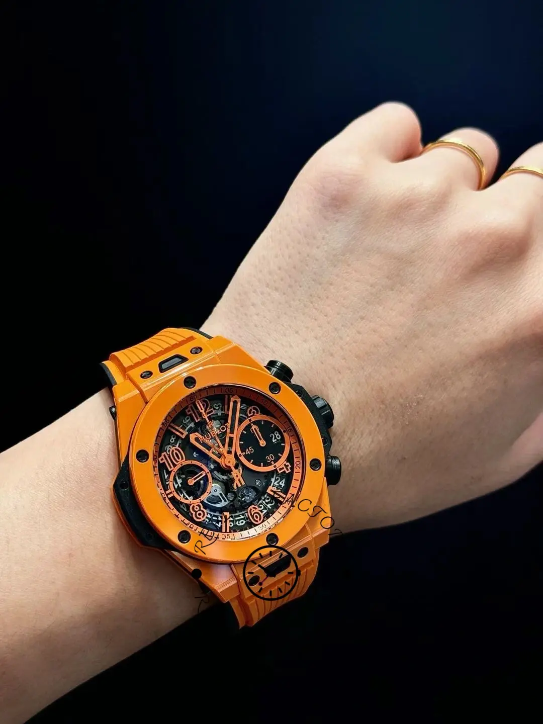 Wrist shot of Hublot Big Bang Unico 441.CU.5910.RX on dark background, orange case contrast.